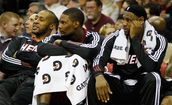CLEVELAND - MARCH 29: LeBron James #6 and Chris Bosh #1 of the Miami Heat sit on the bench during the game against the Cleveland Cavaliers on March 29, 2011 at Quicken Loans Arena in Cleveland, Ohio. NOTE TO USER: User expressly acknowledges and agrees th