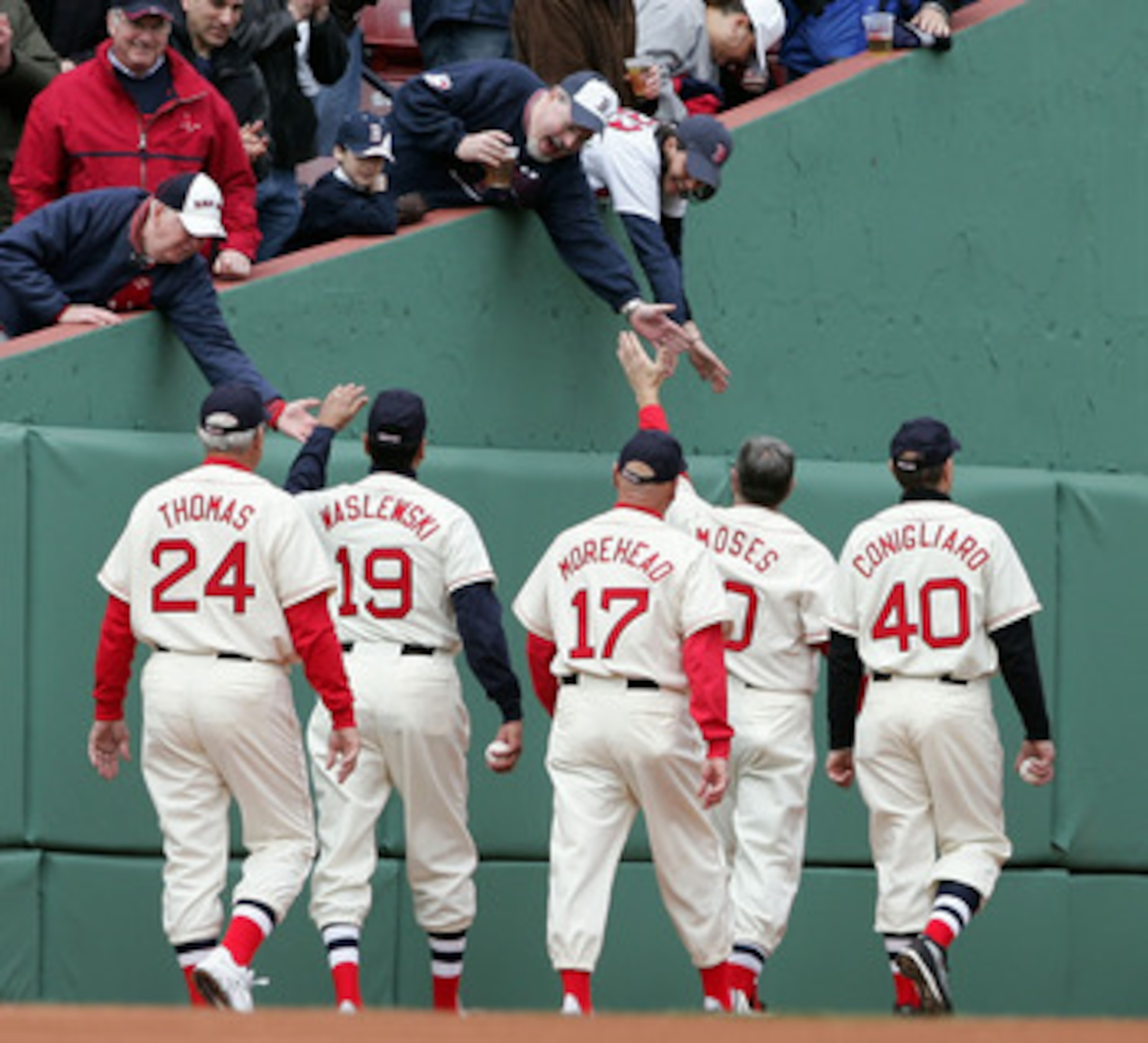BOSTON - APRIL 10: George Thomas #24, Gary Waslewski #19, Dave Morehead #17, Jerry Moses #10 and Tony Conigliaro #40 of the 1967 Boston Red Sox walk off the field before the 2007 Red Sox were to take on the Seattle Mariners on opening day at Fenway Park o
