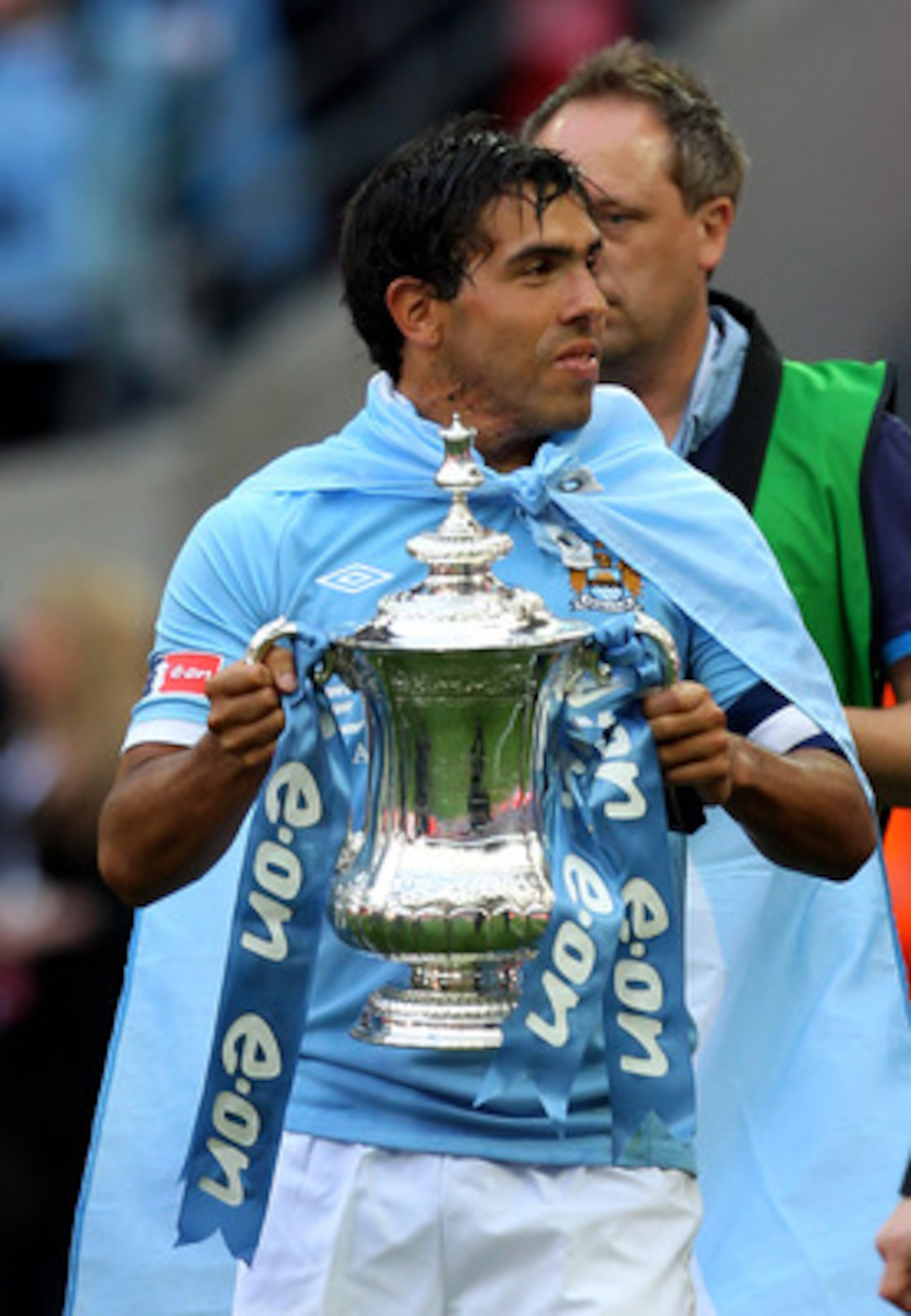 LONDON, ENGLAND - MAY 14:  Carlos Tevez celebrates with the trophy after he and his Manchester City team mates won the FA Cup sponsored by E.ON Final match between Manchester City and Stoke City at Wembley Stadium on May 14, 2011 in London, England.  (Pho