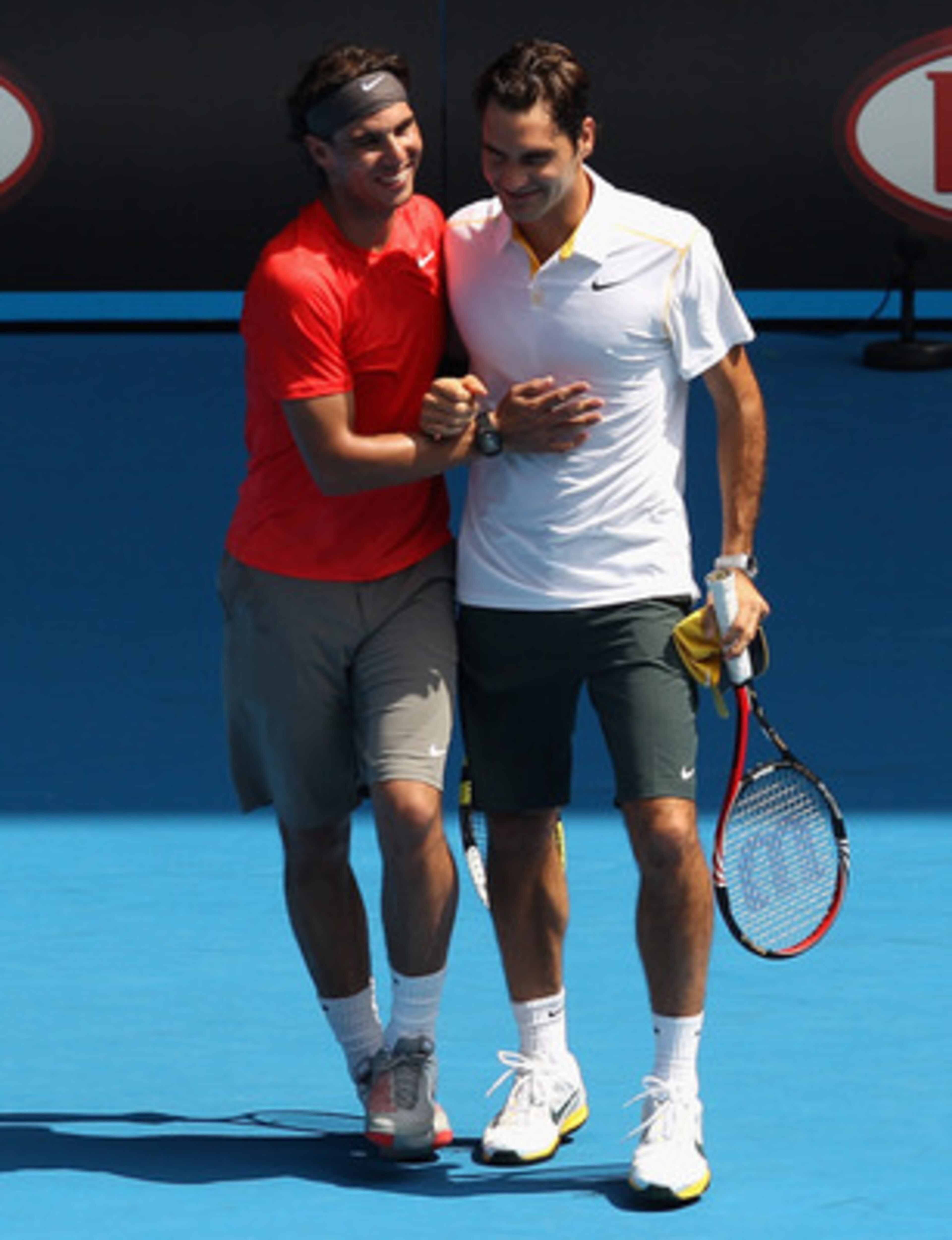 MELBOURNE, AUSTRALIA - JANUARY 16:  Rafael Nadal of Spain and Roger Federer of Switzerland celebrate a point during the 'Rally For Relief' charity exhibition match ahead of the 2011 Australian Open at Melbourne Park on January 16, 2011 in Melbourne, Austr