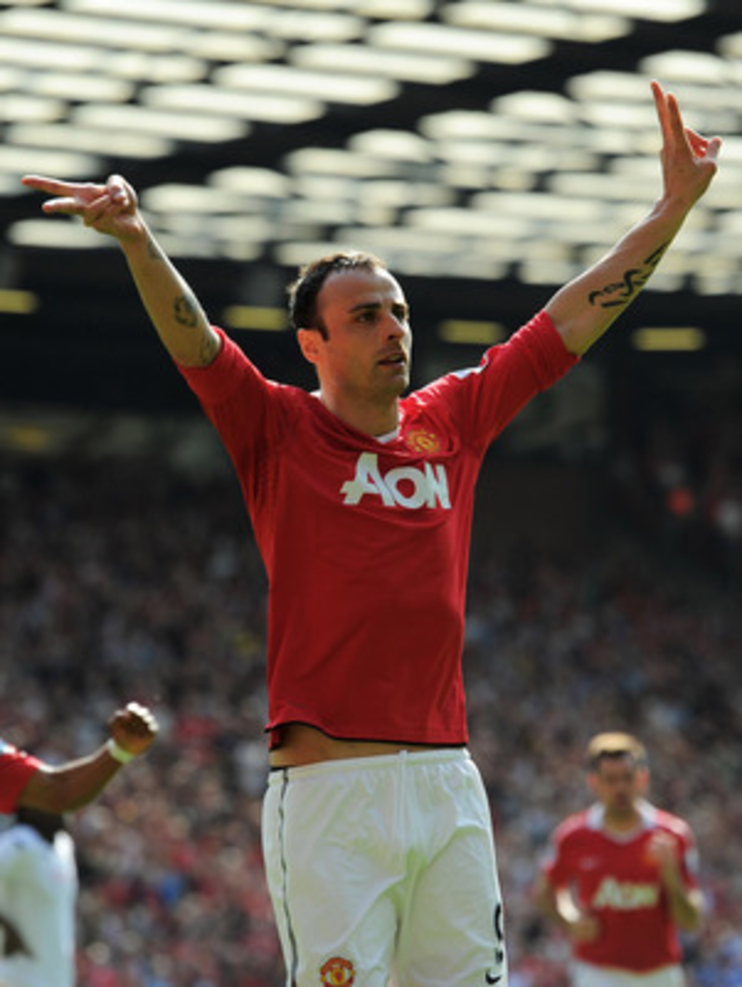 MANCHESTER, ENGLAND - APRIL 09:  Dimitar Berbatov of Manchester United celebrates scoring the opening goal during the Barclays Premier League match between Manchester United and Fulham at Old Trafford on April 9, 2011 in Manchester, England.  (Photo by Mi