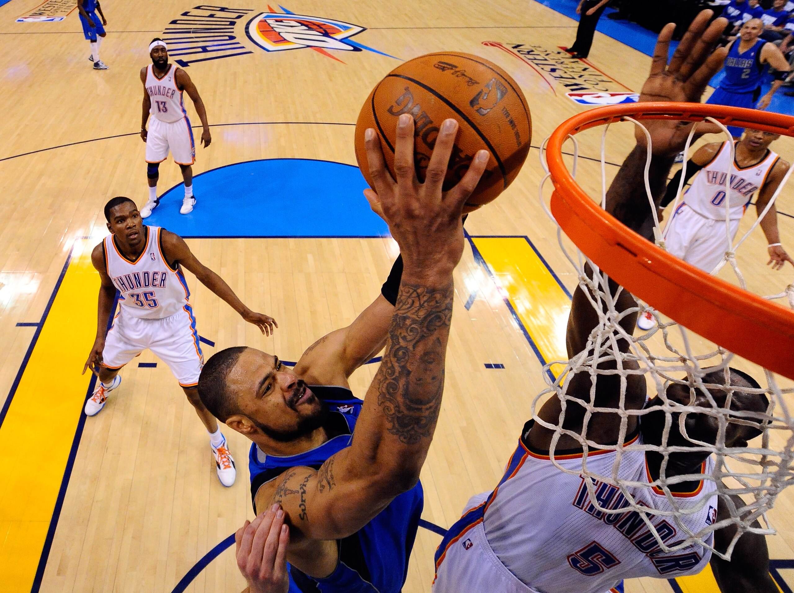 OKLAHOMA CITY, OK - MAY 21:  Tyson Chandler #6 of the Dallas Mavericks goes up for a shot over Kendrick Perkins #5 of the Oklahoma City Thunder in the first half in Game Three of the Western Conference Finals during the 2011 NBA Playoffs at Oklahoma City