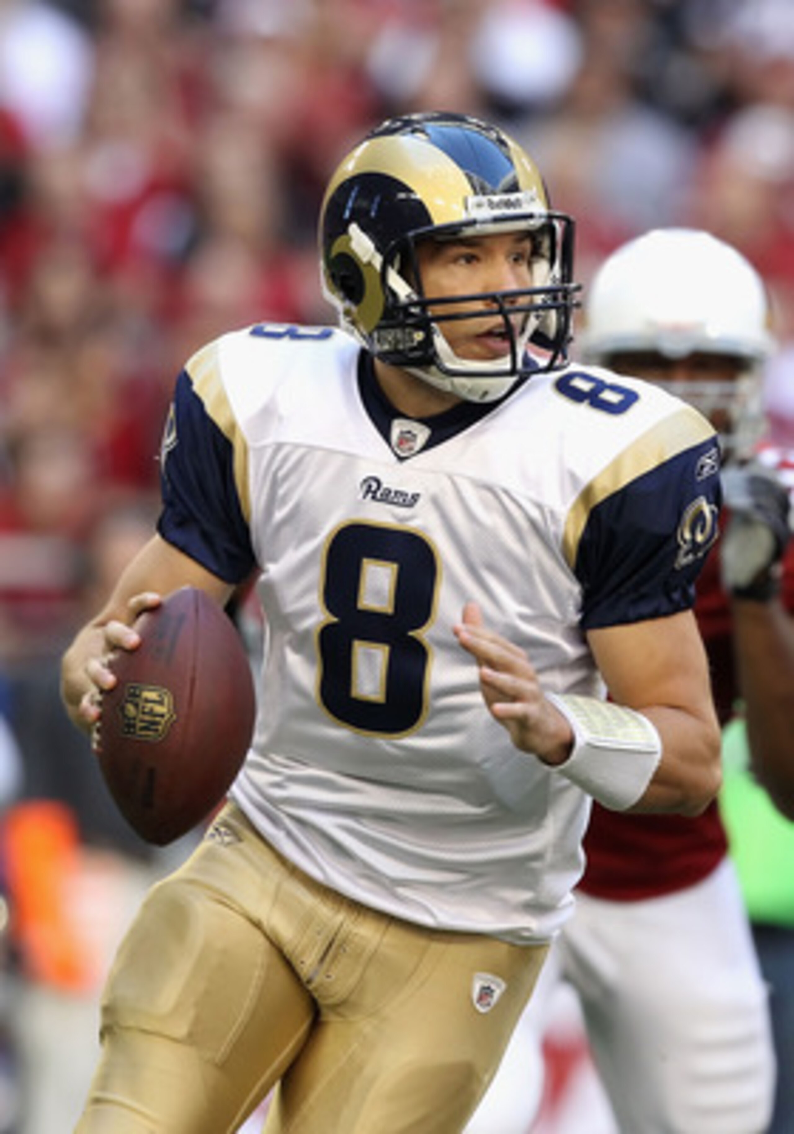 GLENDALE, AZ - DECEMBER 05:  Quarterback Sam Bradford #8 of the St. Louis Rams scrambles to pass the football during the NFL game against the Arizona Cardinals at the University of Phoenix Stadium on December 5, 2010 in Glendale, Arizona. The Rams defeate