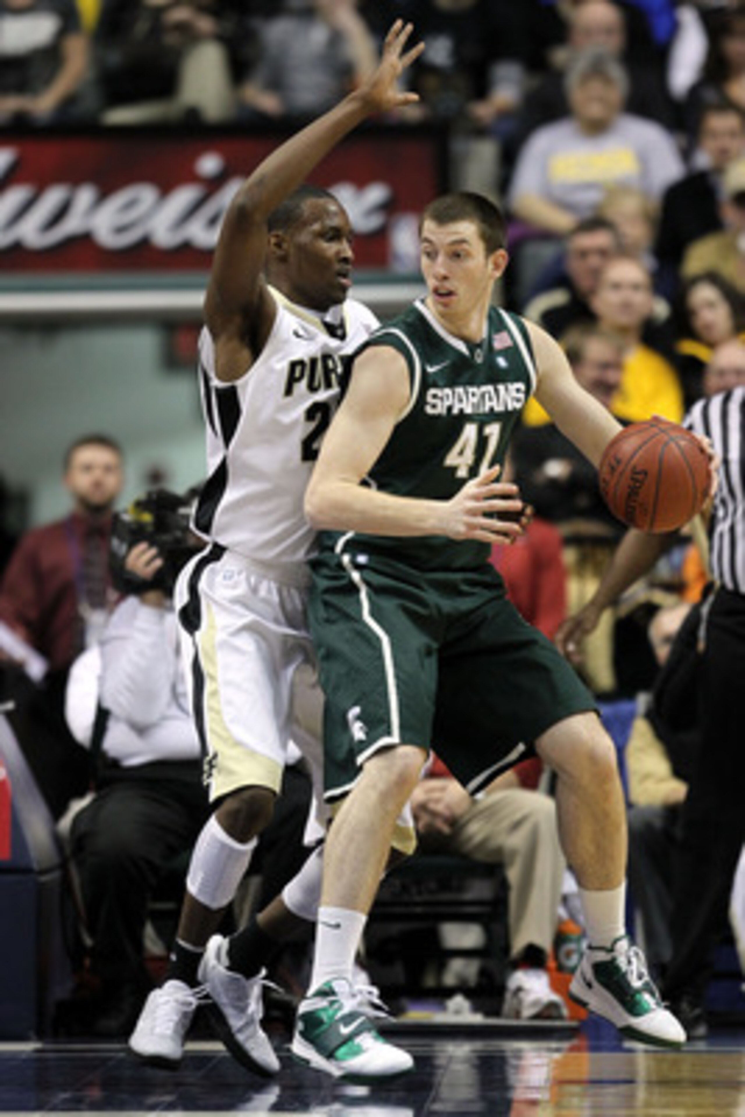 INDIANAPOLIS, IN - MARCH 11:  Garrick Sherman #41 of the Michigan State Spartans looks to pass against JaJuan Johnson #25 of the Purdue Boilermakers during the quarterfinals of the 2011 Big Ten Men's Basketball Tournament at Conseco Fieldhouse on March 11