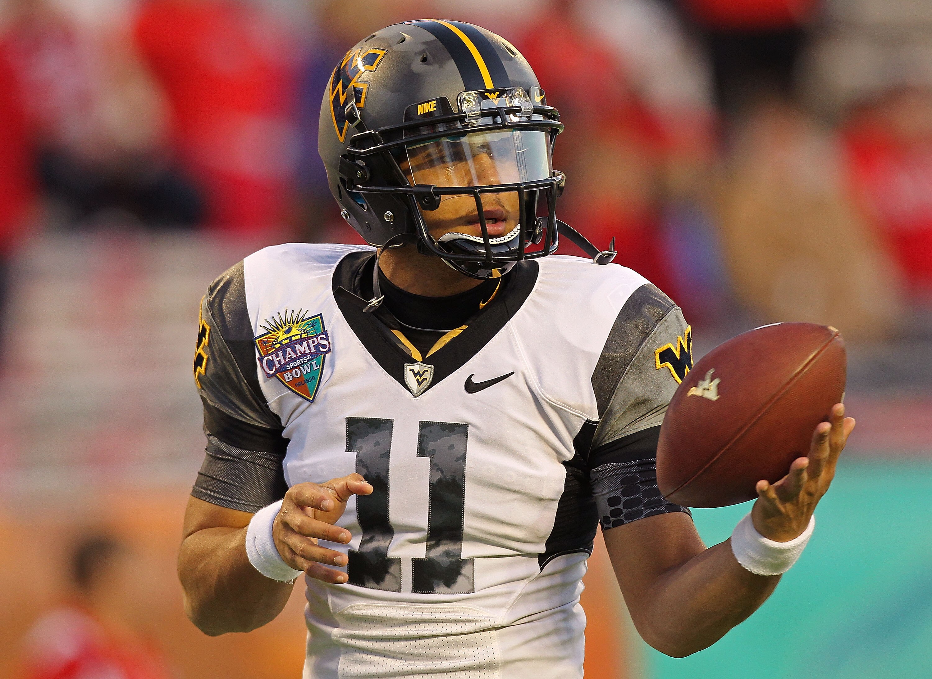 ORLANDO, FL - DECEMBER 28: Barry Brunetti #11 of the West Virginia Mountineers warms up during the Champs Sports Bowl against the North Carolina State Wolfpack at Florida Citrus Bowl Stadium on December 28, 2010 in Orlando, Florida. (Photo by Mike Ehrma ORLANDO, FL - DECEMBER 28: Barry Brunetti #11 of the West Virginia Mountineers warms up during the Champs Sports Bowl against the North Carolina State Wolfpack at Florida Citrus Bowl Stadium on December 28, 2010 in Orlando, Florida. (Photo by Mike Ehrma
