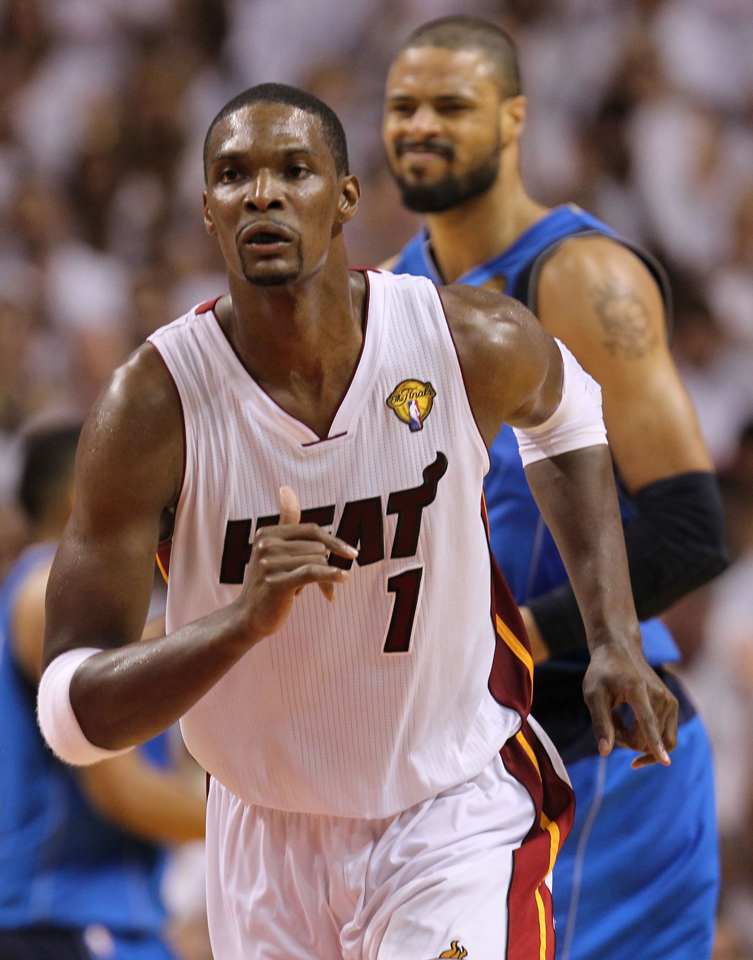 MIAMI, FL - MAY 31:  Chris Bosh #1 of the Miami Heat runs back up court ahead of Tyson Chandler #6 of the Dallas Mavericks in Game One of the 2011 NBA Finals at American Airlines Arena on May 31, 2011 in Miami, Florida. NOTE TO USER: User expressly acknow