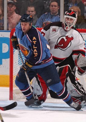 ATLANTA - DECEMBER 23:  Jon Sim #14 of the Atlanta Thrashers screens Goalie Martin Brodeur #30 of the New Jersey Devils at Philips Arena December 23, 2006 in Atlanta, Georgia.  (Photo by Scott Cunningham/Getty Images)