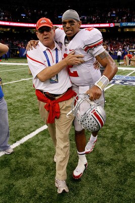 NEW ORLEANS, LA - JANUARY 04:  (M) Quarterback Terrelle Pryor #2 of the Ohio State Buckeyes is helped off the field by a member of the Buckeyes support team after the Buckeyes 31-26 victory against the Arkansas Razorbacks during the Allstate Sugar Bowl at