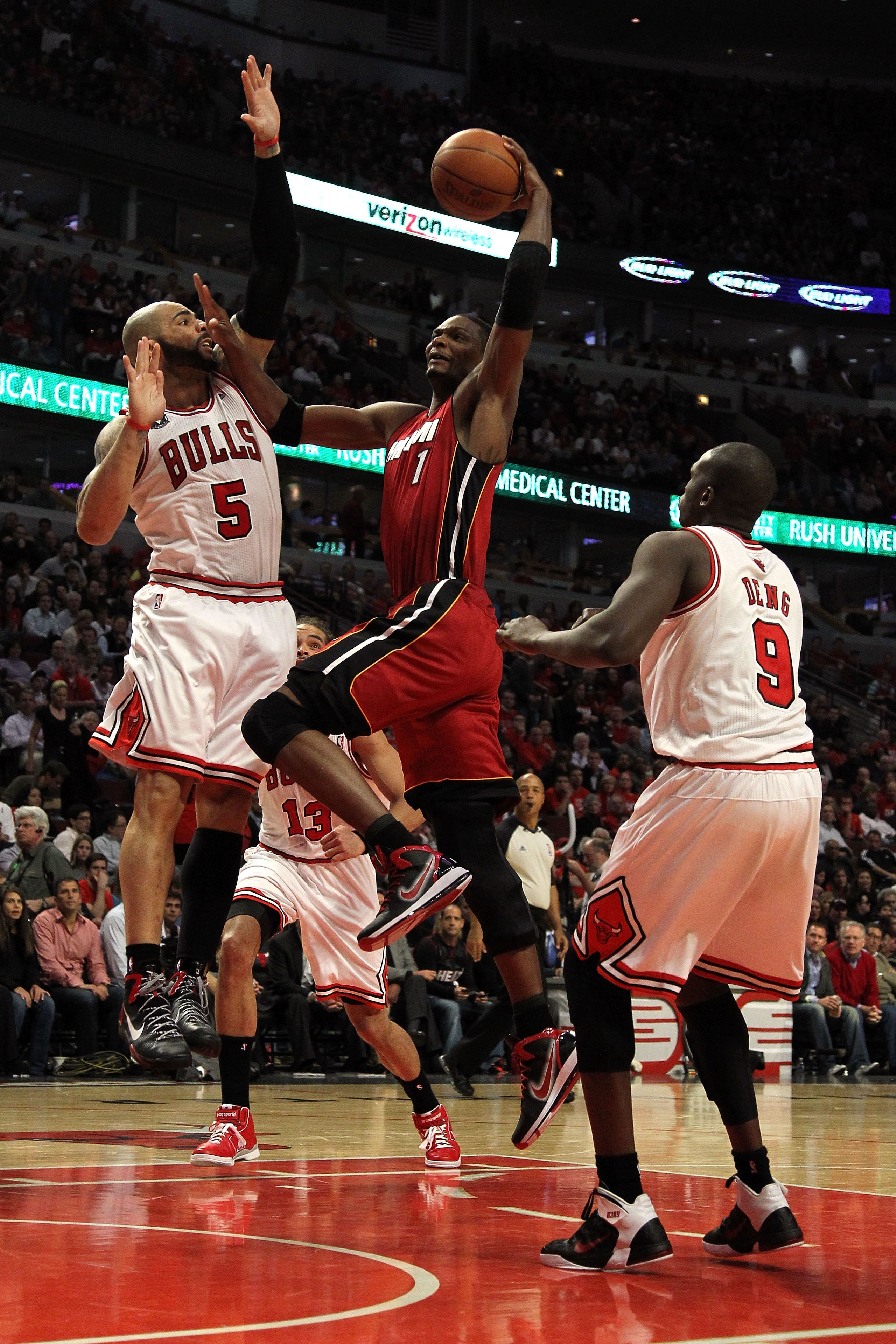 CHICAGO, IL - MAY 26:  Chris Bosh #1 of the Miami Heat drives for a shot attempt against Carlos Boozer #5 and Luol Deng #9 of the Chicago Bulls in Game Five of the Eastern Conference Finals during the 2011 NBA Playoffs on May 26, 2011 at the United Center