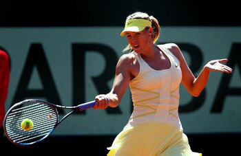PARIS, FRANCE - JUNE 01:  Maria Sharapova of Russia hits a forehand during the women's singles quarterfinal match between Maria Sharapova of Russia and Andrea Petkovic of Germany on day eleven of the French Open at Roland Garros on June 1, 2011 in Paris, 