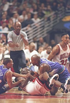 4 Jun 1997: Guard Michael Jordan and Scottie Pippen of the Chicago Bulls and guard Howard Eisley and forward Bryon Russell of the Utah Jazz fight for the ball during a playoff game at the United Center in Chicago, Illinois. The Bulls won the game 97-85.