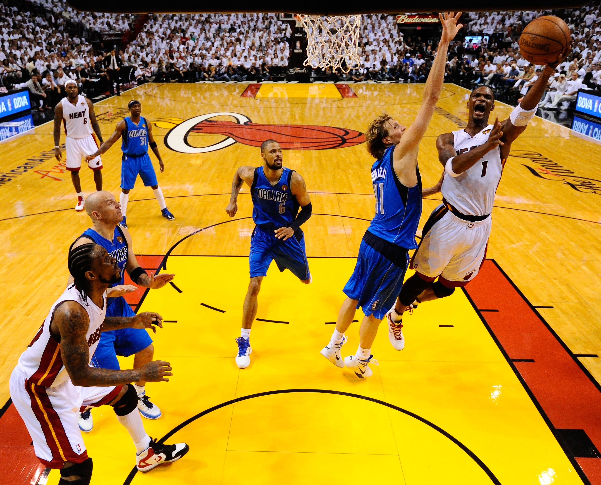 MIAMI, FL - MAY 31:  Chris Bosh #1 of the Miami Heat drives for a shot attempt against Dirk Nowitzki #41 of the Dallas Mavericks in Game One of the 2011 NBA Finals at American Airlines Arena on May 31, 2011 in Miami, Florida. NOTE TO USER: User expressly