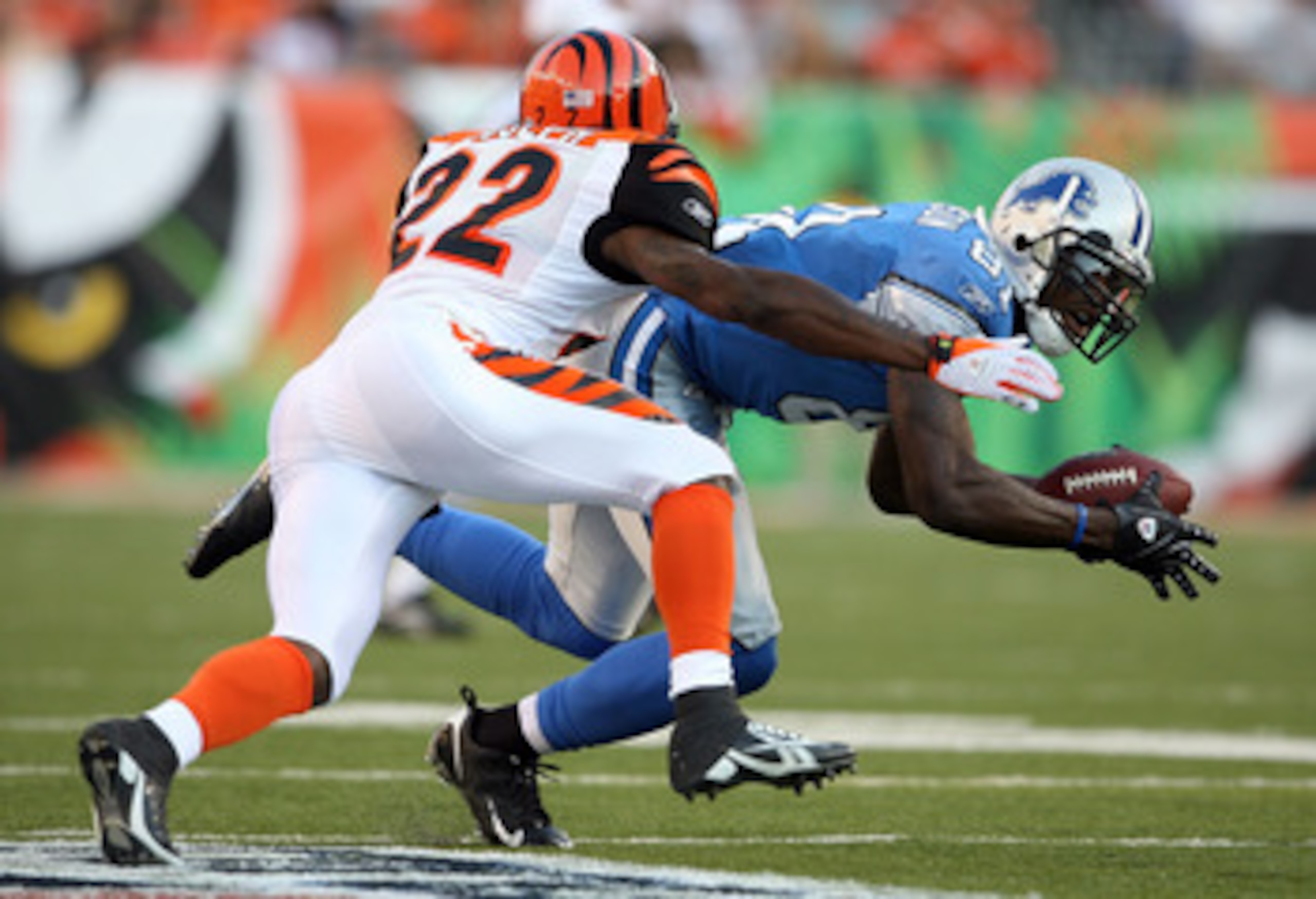 CINCINNATI - AUGUST 17:  Calvin Johnson #81 of the Detoit Lions catches a pass while defended by Johnathan Joseph #22 of the Cincinnati Bengals during the NFL game against  at Paul Brown Stadium on August 17, 2008 in Cincinnati, Ohio.  (Photo by Andy Lyon