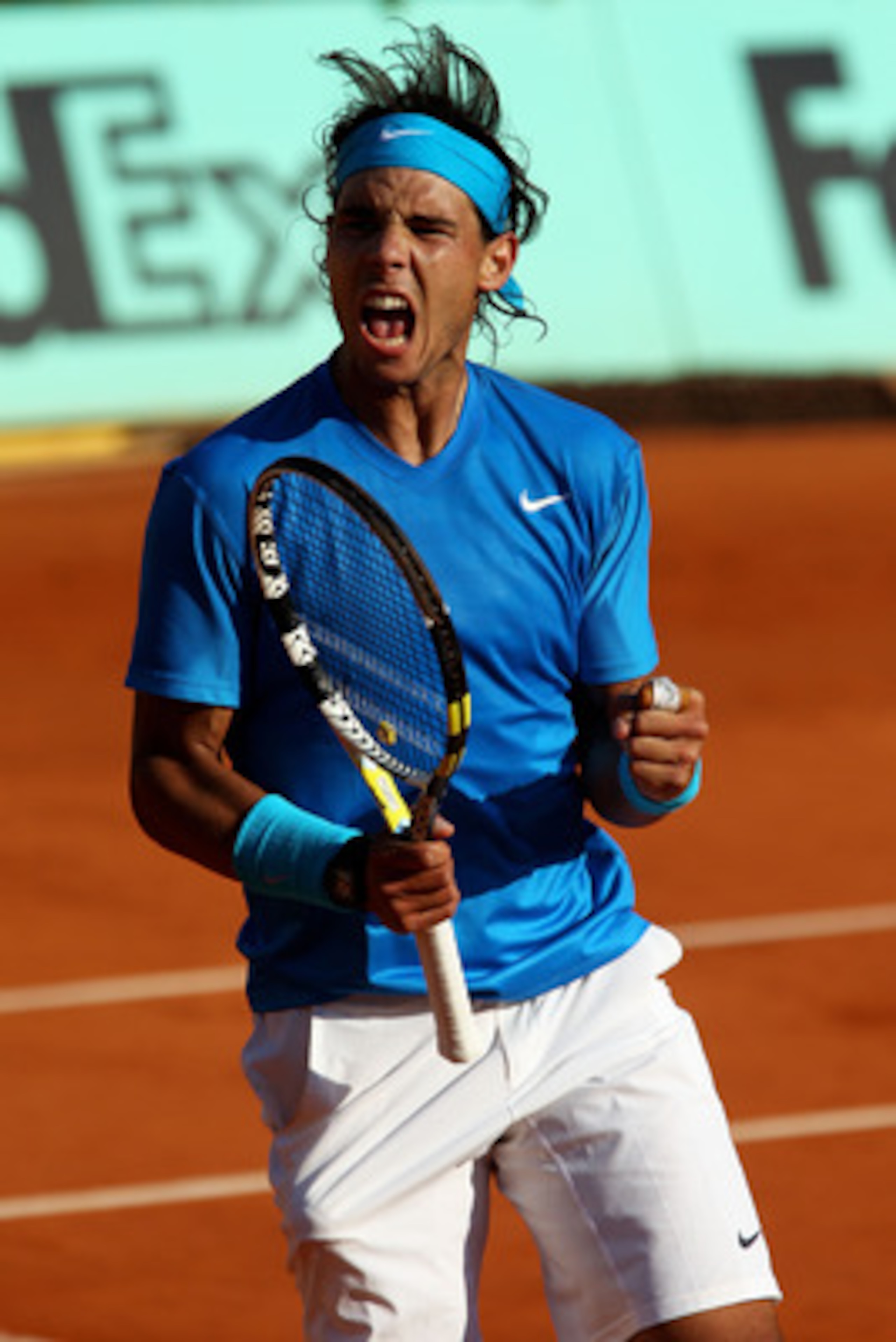 PARIS, FRANCE - JUNE 01: Rafael Nadal of Spain celebrates a point during the men's singles quarterfinal match between Rafael Nadal of Spain and Robin Soderling of Sweden on day eleven of the French Open at Roland Garros on June 1, 2011 in Paris, France. PARIS, FRANCE - JUNE 01: Rafael Nadal of Spain celebrates a point during the men's singles quarterfinal match between Rafael Nadal of Spain and Robin Soderling of Sweden on day eleven of the French Open at Roland Garros on June 1, 2011 in Paris, France.