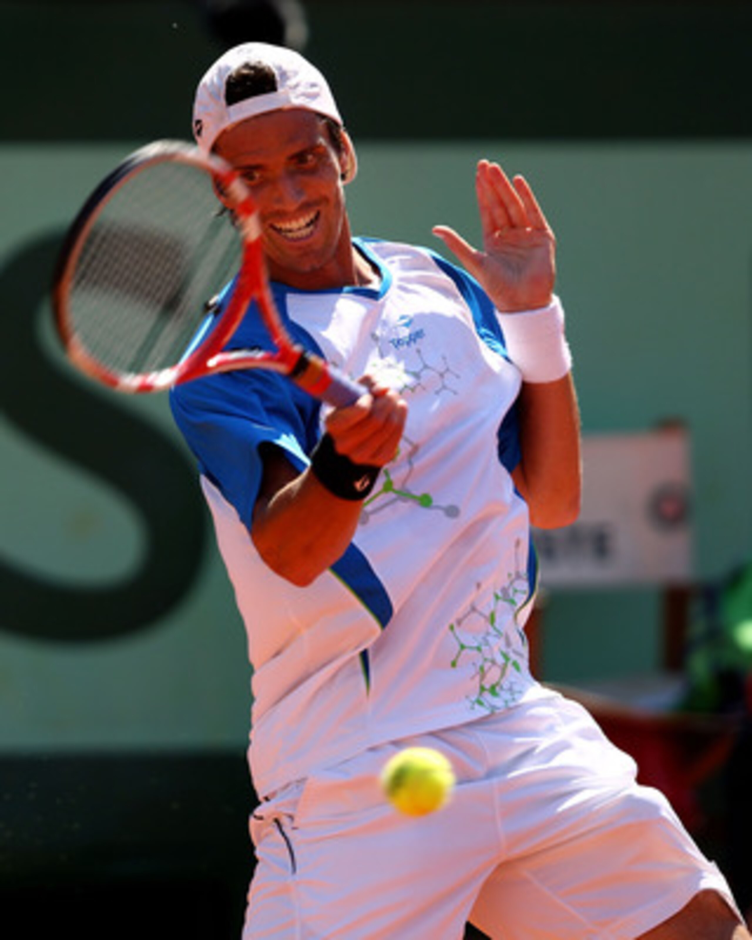 PARIS, FRANCE - JUNE 01: Juan Ignacio Chela of Argentina hits a forehand during the men's singles quarterfinal match between Andy Murray of Great Britain and Juan Ignacio Chela of Argentina on day eleven of the French Open at Roland Garros on June 1, 201 PARIS, FRANCE - JUNE 01: Juan Ignacio Chela of Argentina hits a forehand during the men's singles quarterfinal match between Andy Murray of Great Britain and Juan Ignacio Chela of Argentina on day eleven of the French Open at Roland Garros on June 1, 201