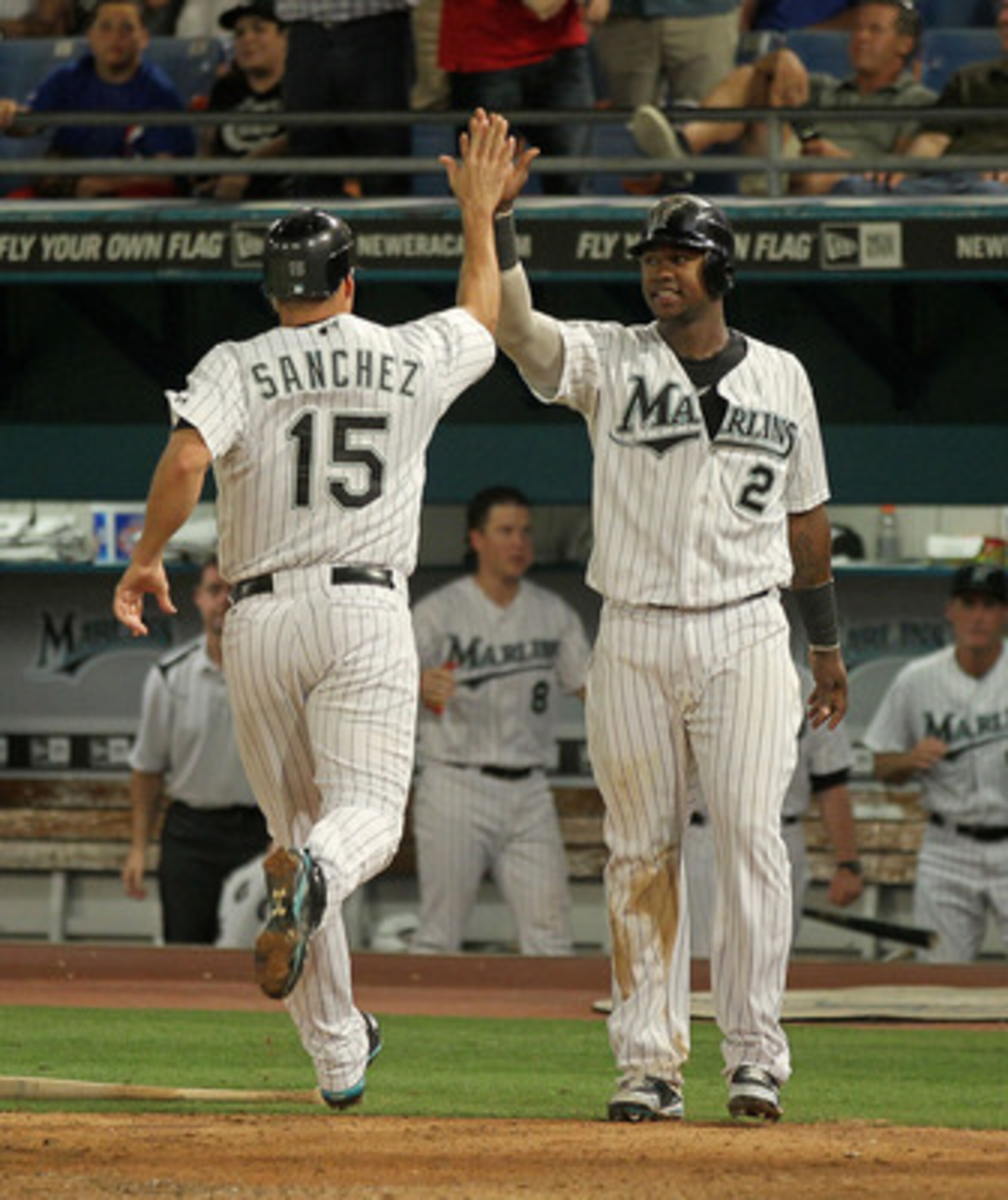MIAMI GARDENS, FL - MAY 18:  Gaby Sanchez #15 and Hanley Ramirez #2 of the Florida Marlins high-five after Sanchez scored during a game against the Chicago Cubs at Sun Life Stadium on May 18, 2011 in Miami Gardens, Florida.  (Photo by Mike Ehrmann/Getty I