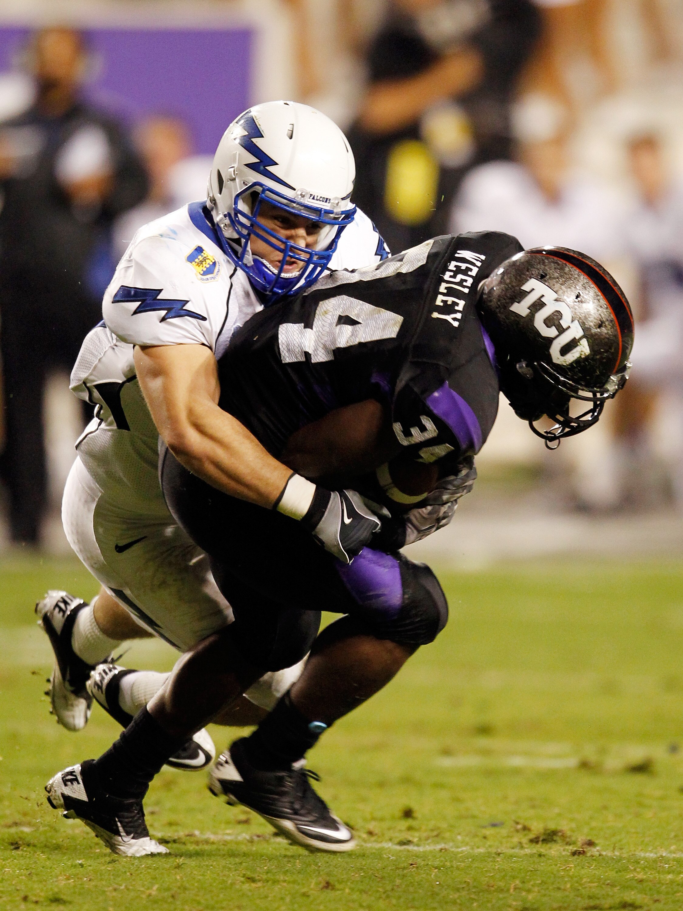 FORT WORTH, TX - OCTOBER 23:  Tailback Ed Wesley #34 of the TCU Horned Frogs carries the ball against linebacker Brady Amack #41 of the Air Force Falcons at Amon G. Carter Stadium on October 23, 2010 in Fort Worth, Texas.  (Photo by Tom Pennington/Getty I