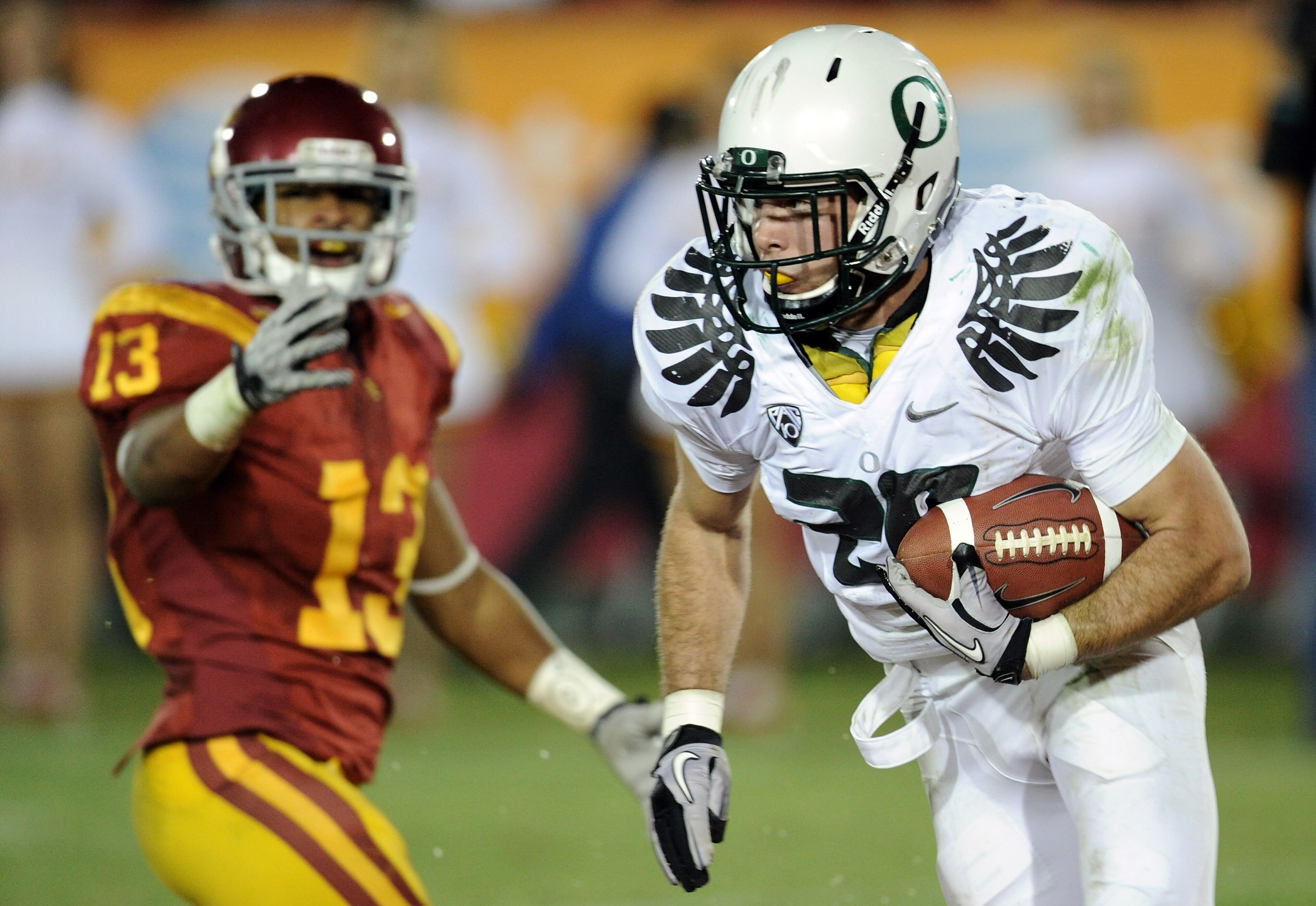 LOS ANGELES, CA - OCTOBER 30:  John Boyett #20 of the Oregon Ducks makes an interception in front of Robert Woods #13 of the USC Trojans at Los Angeles Memorial Coliseum on October 30, 2010 in Los Angeles, California.  (Photo by Harry How/Getty Images)