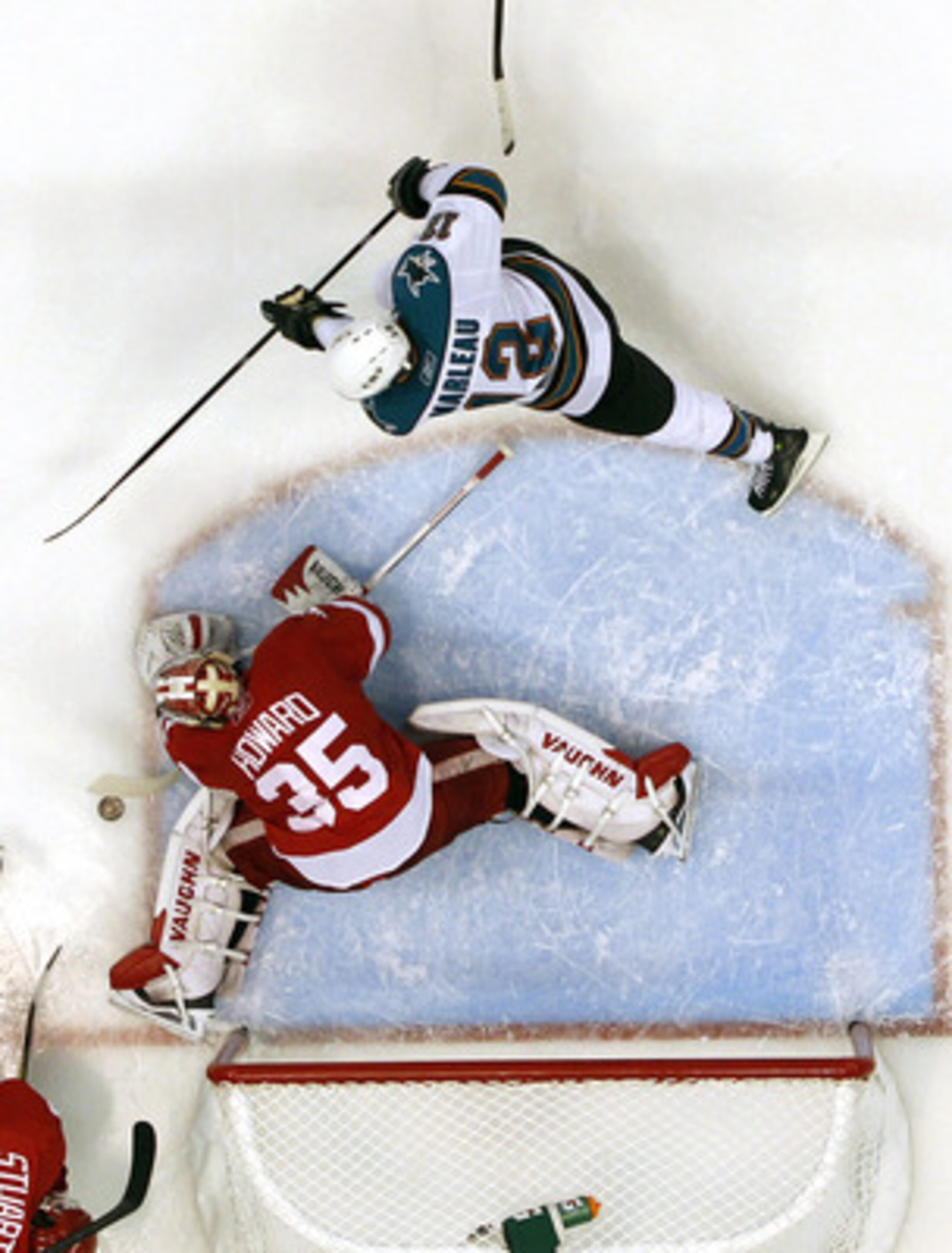DETROIT - MAY 10: Jimmy Howard #35 of the Detroit Red Wings stops a second period shot by Patrick Marleau #12 of the San Jose Sharks in Game Six of the Western Conference Semifinals during the 2011 NHL Stanley Cup Playoffs on May 10, 2011 at Joe Louis Are DETROIT - MAY 10: Jimmy Howard #35 of the Detroit Red Wings stops a second period shot by Patrick Marleau #12 of the San Jose Sharks in Game Six of the Western Conference Semifinals during the 2011 NHL Stanley Cup Playoffs on May 10, 2011 at Joe Louis Are