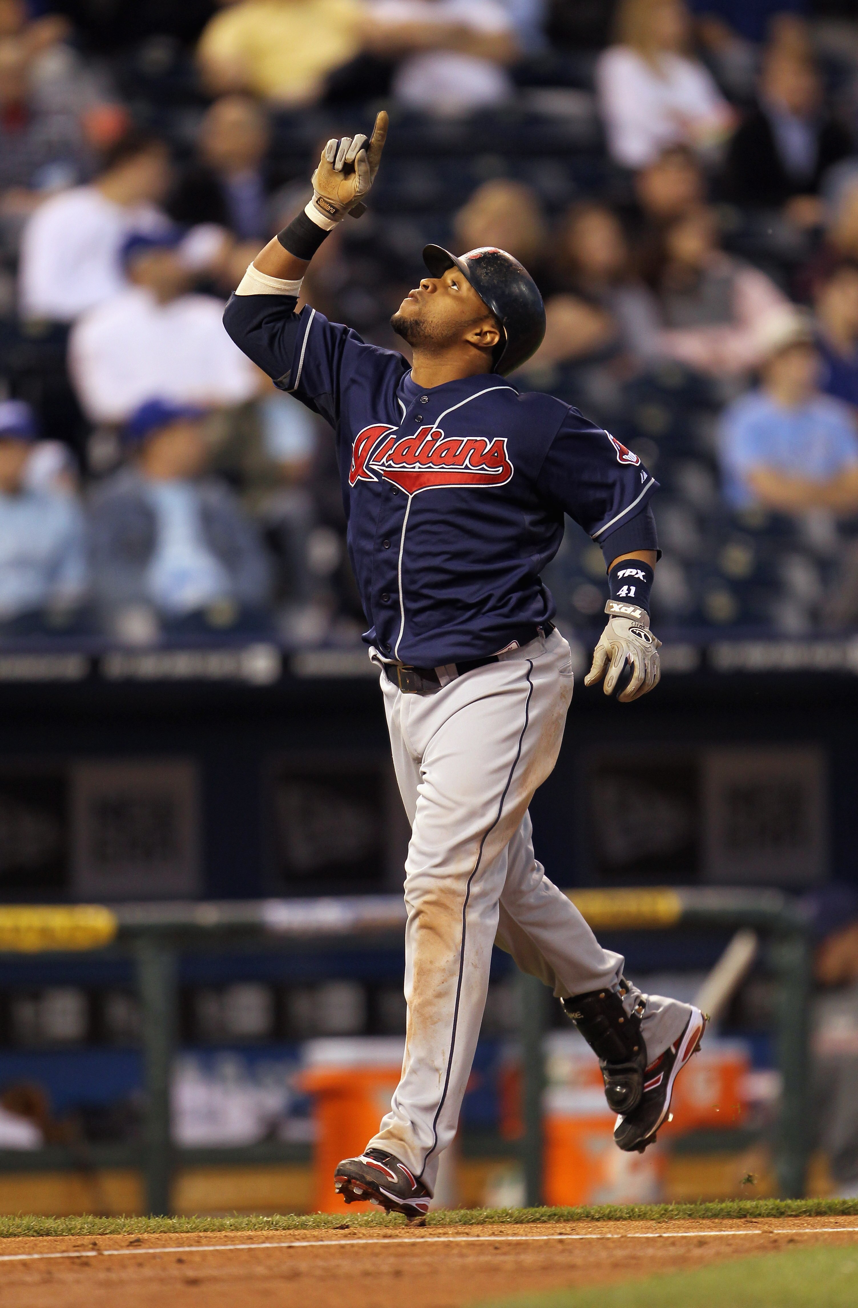 KANSAS CITY, MO - MAY 17:  Carlos Santana #41 of the Cleveland Indians points skyward as he crosses home plate after a solo home run during the 5th inning of the game against the Kansas City Royals on May 17, 2011 at Kauffman Stadium in Kansas City, Misso