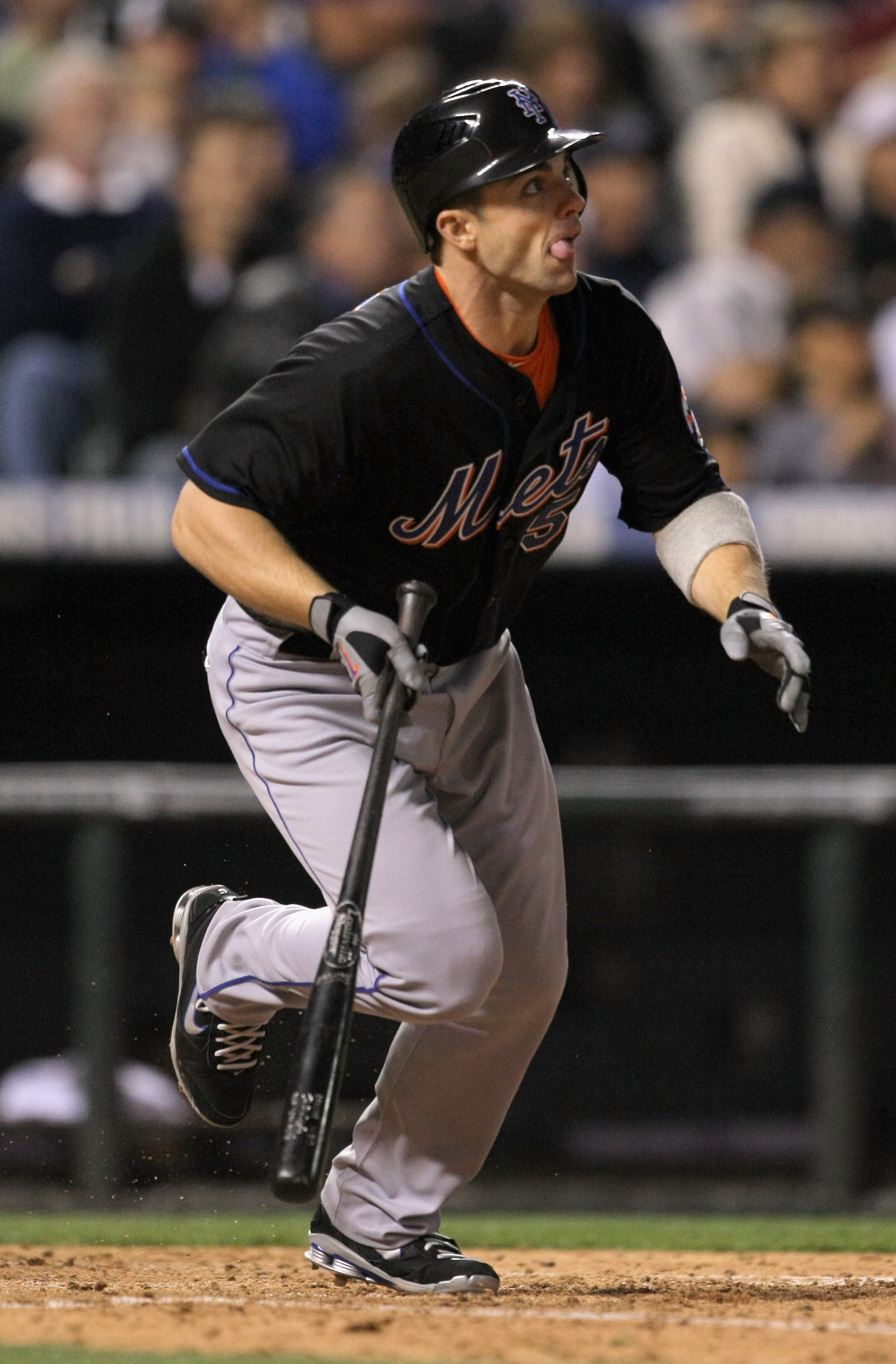 DENVER, CO - MAY 09:  Third baseman David Wright #5 of the New York Mets singles on a soft fly to rightfield off of pitcher Matt Belisle #34 of the Colorado Rockies in the seventh inning at Coors Field on May 9, 2011 in Denver, Colorado.  (Photo by Doug P