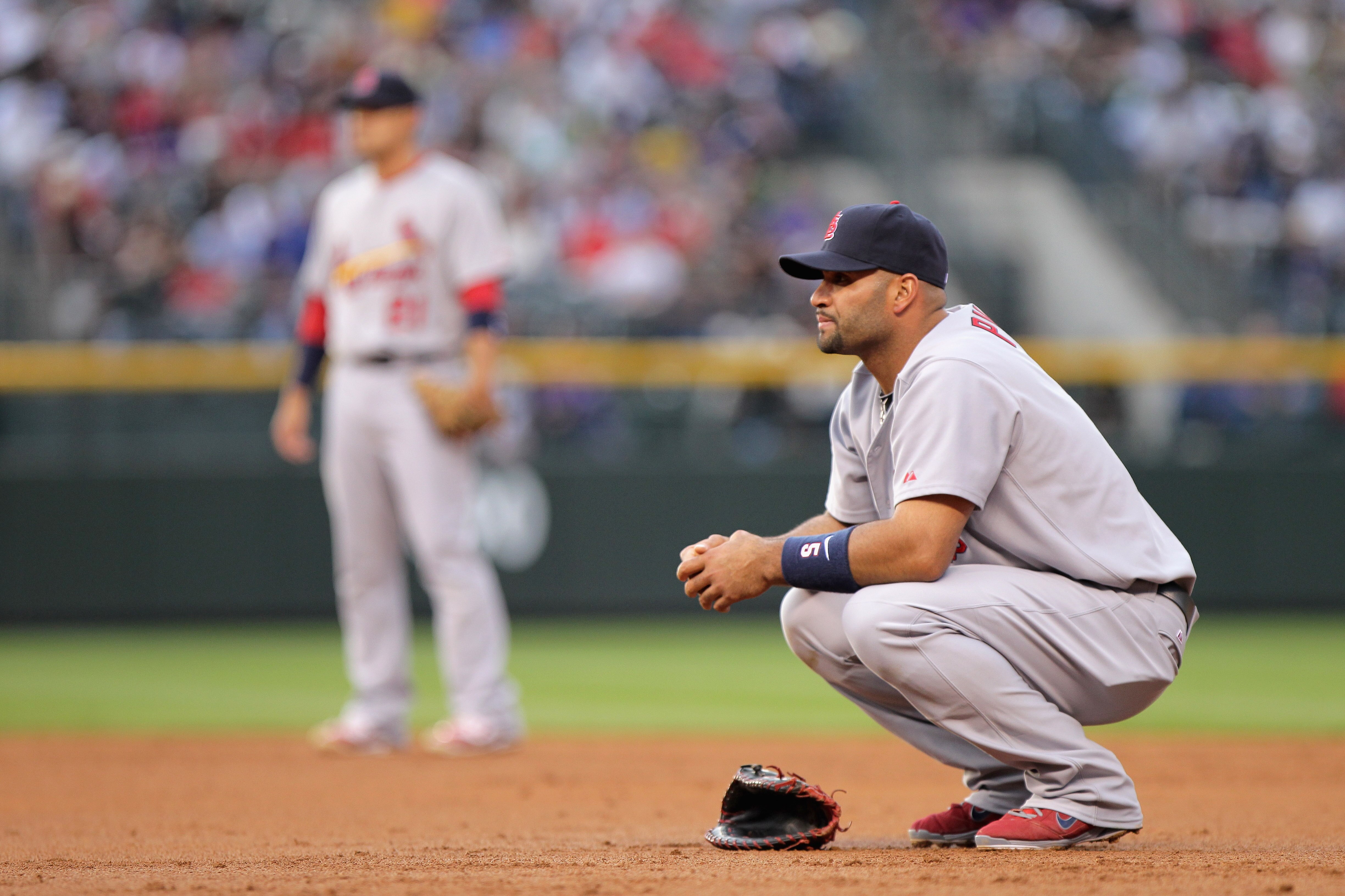 DENVER, CO - MAY 27:  First baseman Albert Pujols #5 of the St. Louis Cardinals looks on during a break i n the action against the Colorado Rockies at Coors Field on May 27, 2011 in Denver, Colorado.  (Photo by Doug Pensinger/Getty Images)