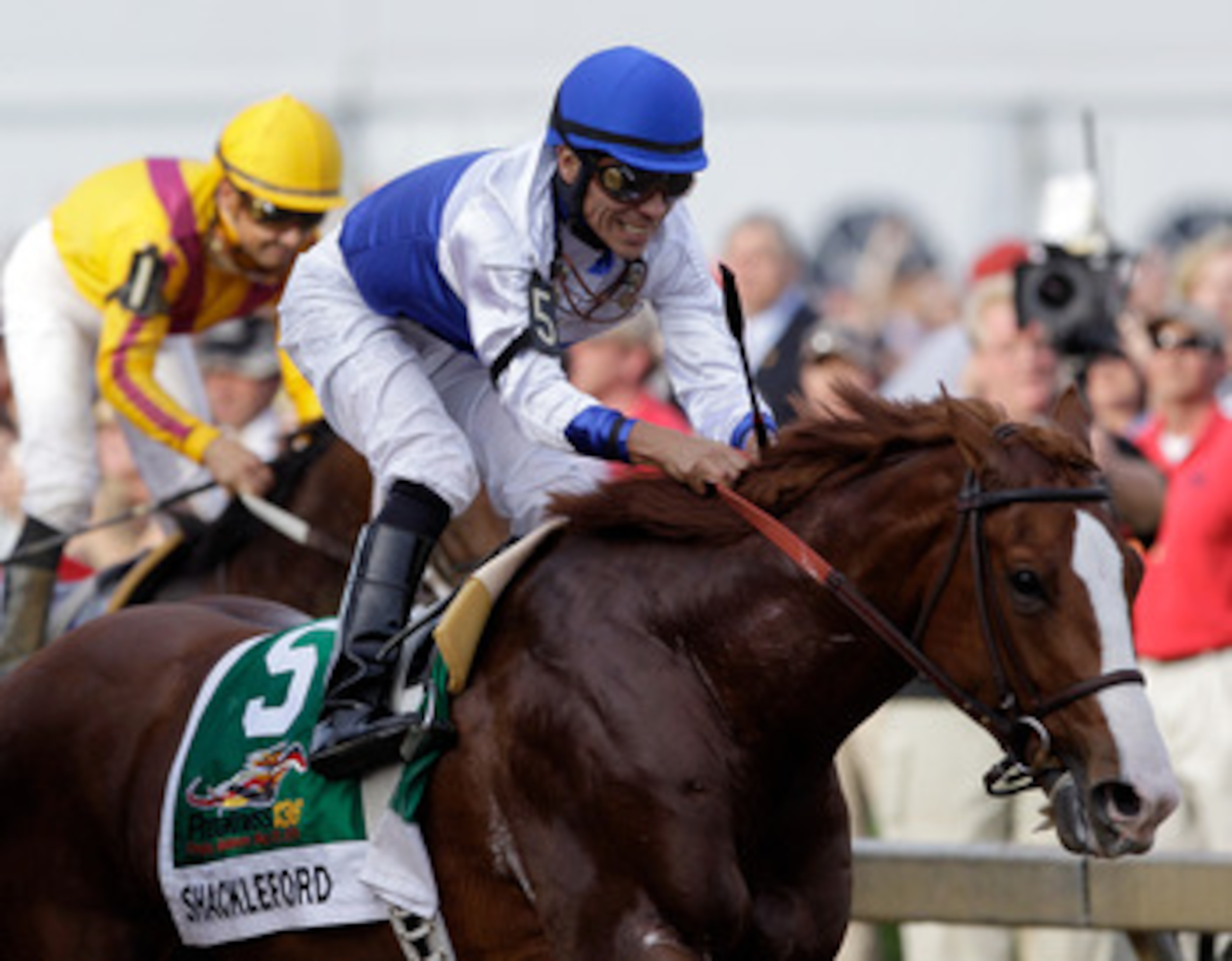 BALTIMORE, MD - MAY 21:  Jockey Jesus Castanon smiles after crossing the finish line aboard Shackleford #5 to win the 136th running of the Preakness Stakes at Pimlico Race Course on May 21, 2011 in Baltimore, Maryland.  (Photo by Rob Carr/Getty Images)