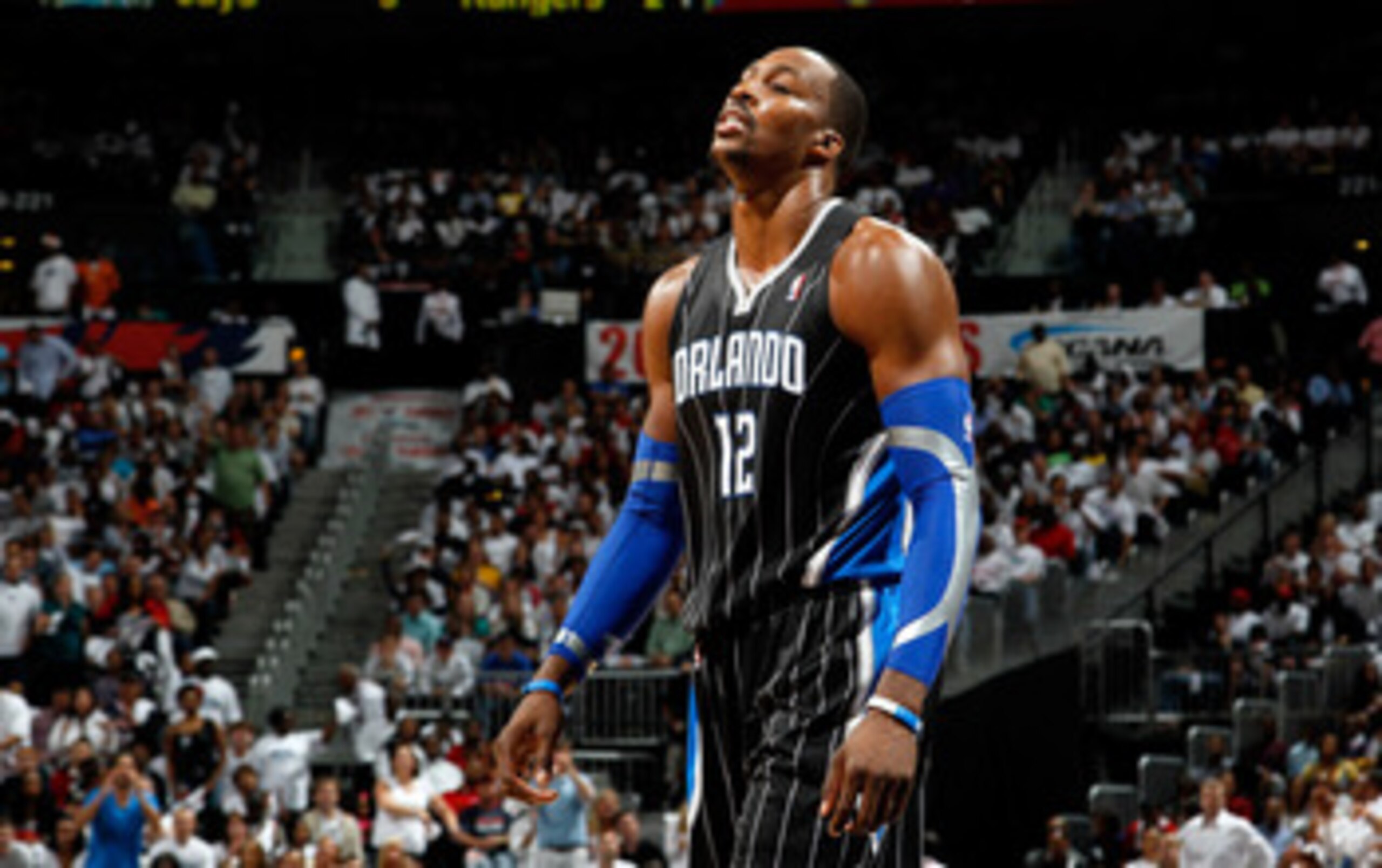 ATLANTA, GA - APRIL 28:  Dwight Howard #12 of the Orlando Magic walks to the bench after a turnover to the Atlanta Hawks during Game Six of the Eastern Conference Quarterfinals in the 2011 NBA Playoffs at Philips Arena on April 28, 2011 in Atlanta, Georgi