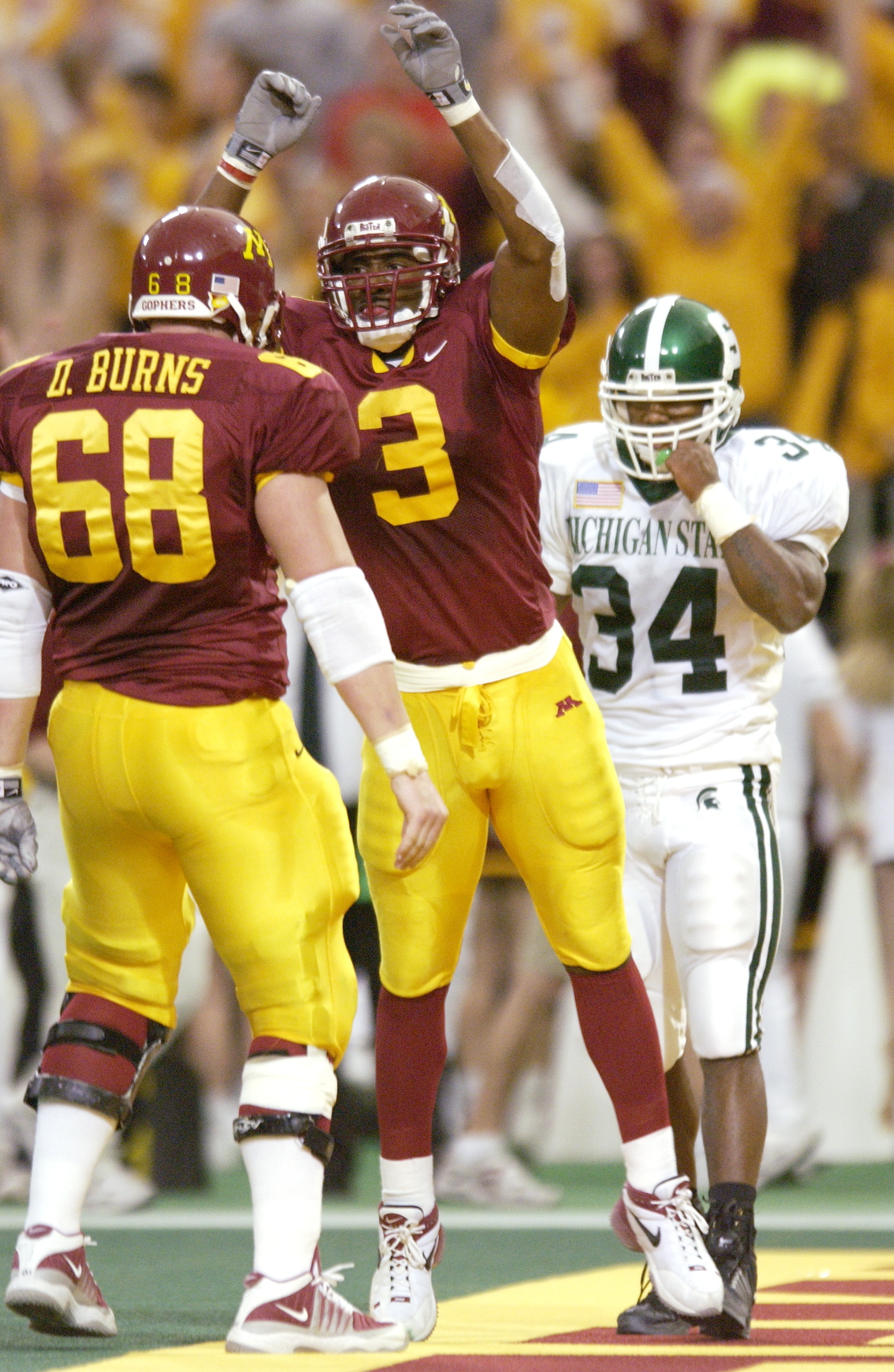 20 Oct 2001:  Ron Johnson #3 of Minnesota celebrates a touchdown against Michigan State with teammate Derek Burns during the game at Hubert H. Humphrey Metrodome in Minneapolis, Minnesota.  The Minnesota Gophers won 28-19. DIGITAL IMAGE. Mandatory Credit: