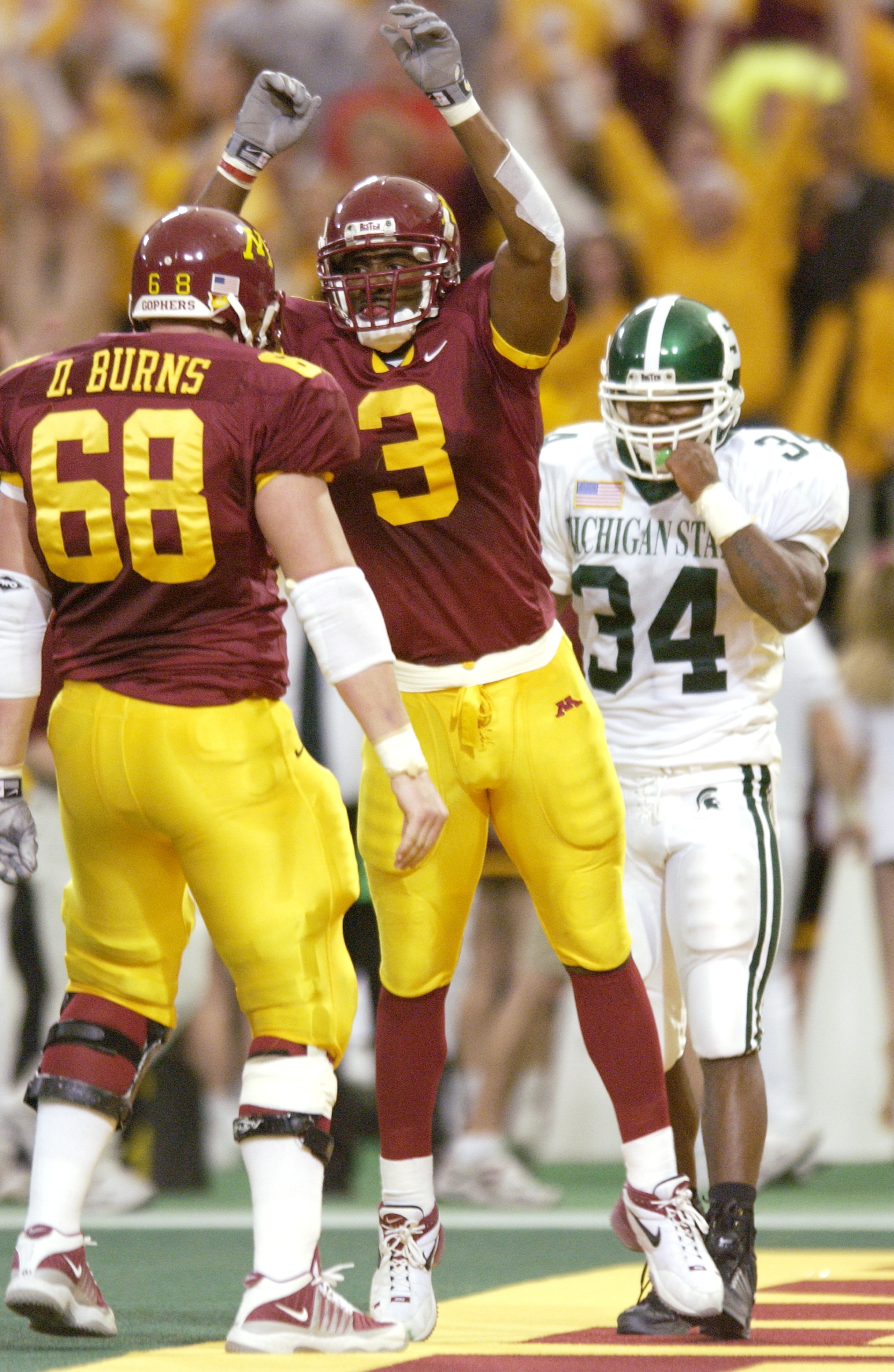 20 Oct 2001: Ron Johnson #3 of Minnesota celebrates a touchdown against Michigan State with teammate Derek Burns during the game at Hubert H. Humphrey Metrodome in Minneapolis, Minnesota. The Minnesota Gophers won 28-19. DIGITAL IMAGE. Mandatory Credit: 20 Oct 2001: Ron Johnson #3 of Minnesota celebrates a touchdown against Michigan State with teammate Derek Burns during the game at Hubert H. Humphrey Metrodome in Minneapolis, Minnesota. The Minnesota Gophers won 28-19. DIGITAL IMAGE. Mandatory Credit: