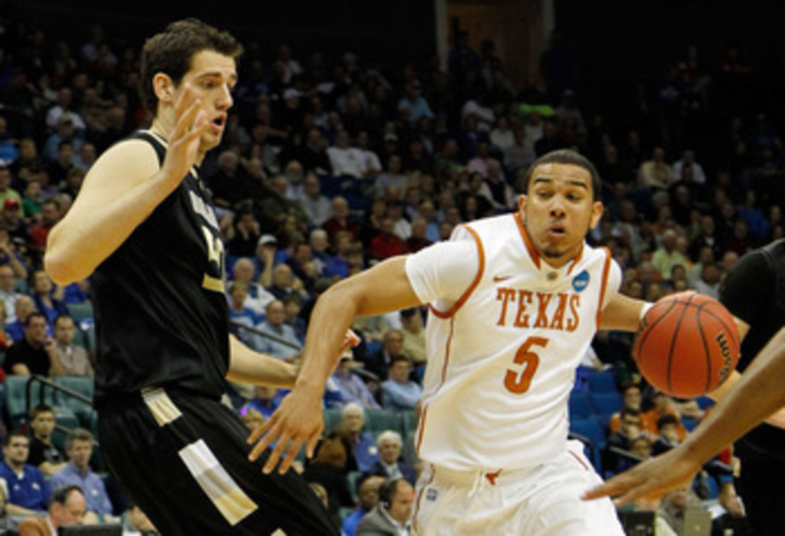 TULSA, OK - MARCH 18:  Cory Joseph #5 of the Texas Longhorns drives with the ball against Ilija Milutinovic #50 of the Oakland Golden Grizzlies during the second round of the 2011 NCAA men's basketball tournament at BOK Center on March 18, 2011 in Tulsa, 