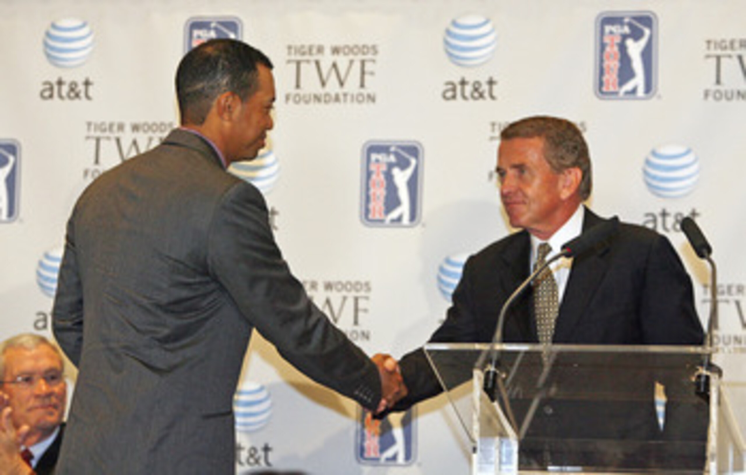 UNITED STATES - MARCH 07:  Tiger Woods shakes hands with Tim Finchem, PGA TOUR commissioner, at a press conference announcing a new PGA TOUR event called the AT&T National, at the National Press Club in Washington, D.C. on Wednesday, March 7, 2006. The PG