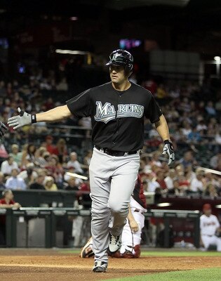 PHOENIX, AZ - MAY 31:  Gaby Sanchez #15 of the Florida Marlins high fives teammate Greg Dobbs #29 after Sanchez hit a solo home run against the Arizona Diamondbacks during the seventh inning of the Major League Baseball game at Chase Field on May 31, 2011