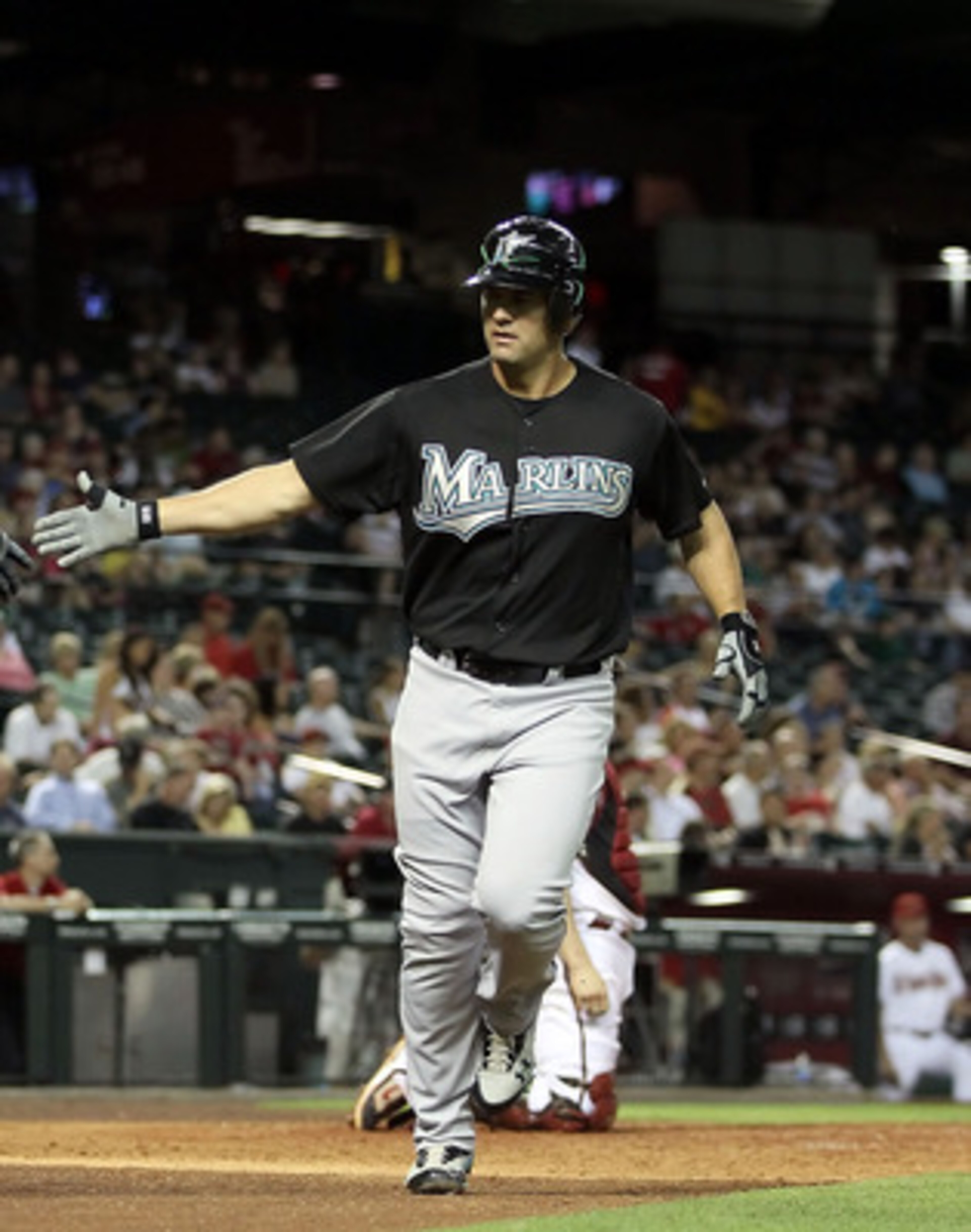 PHOENIX, AZ - MAY 31:  Gaby Sanchez #15 of the Florida Marlins high fives teammate Greg Dobbs #29 after Sanchez hit a solo home run against the Arizona Diamondbacks during the seventh inning of the Major League Baseball game at Chase Field on May 31, 2011