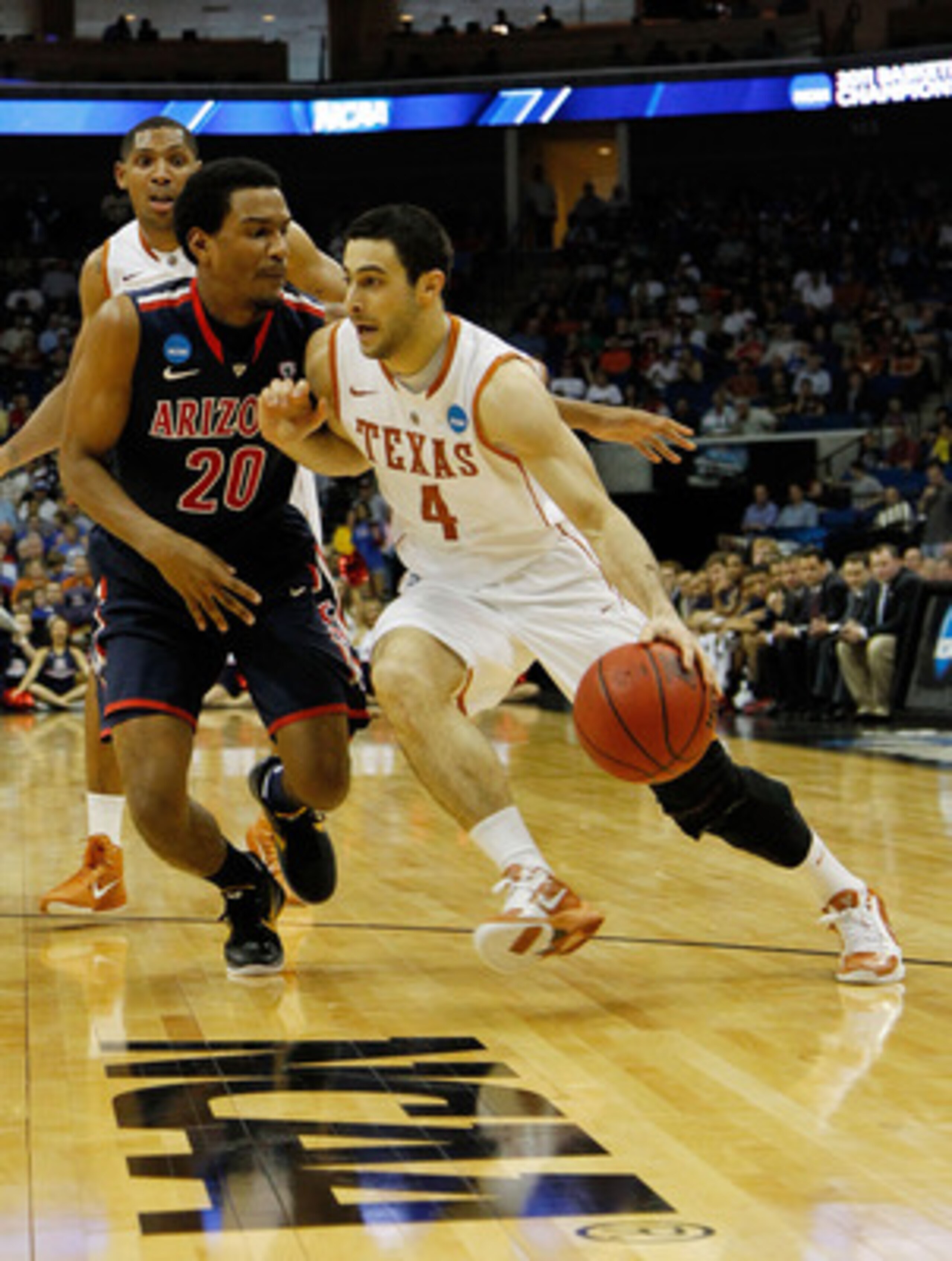 TULSA, OK - MARCH 20:  Dogus Balbay #4 of the Texas Longhorns drives with the ball against Jordin Mayes #20 of the Arizona Wildcats during the third round of the 2011 NCAA men's basketball tournament at BOK Center on March 20, 2011 in Tulsa, Oklahoma.  (P