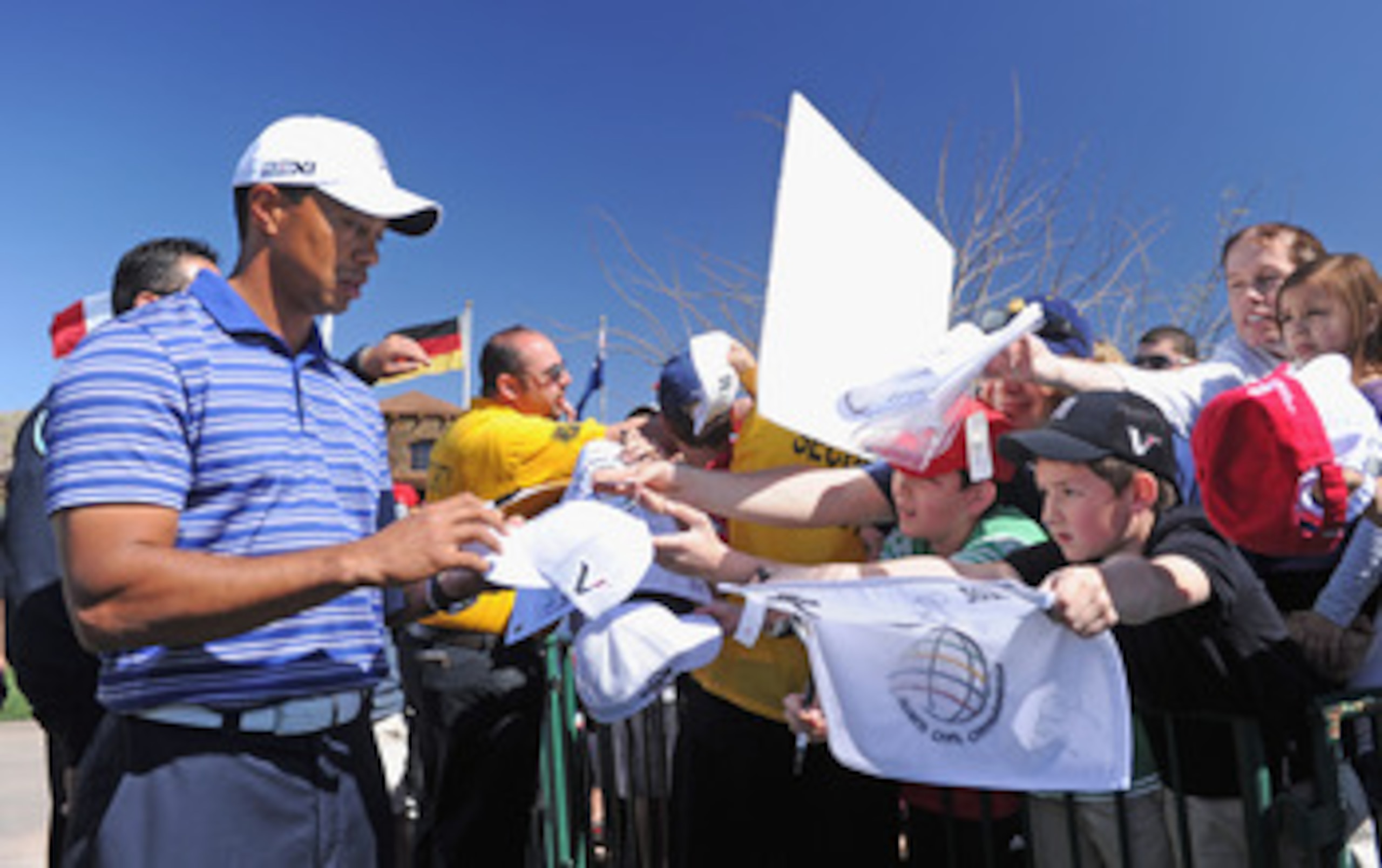 MARANA, AZ - FEBRUARY 22:  Tiger Woods signs autographs during practice prior to the start of the World Golf Championships-Accenture Match Play Championship held at The Ritz-Carlton Golf Club, Dove Mountain on February 22, 2011 in Marana, Arizona.  (Photo