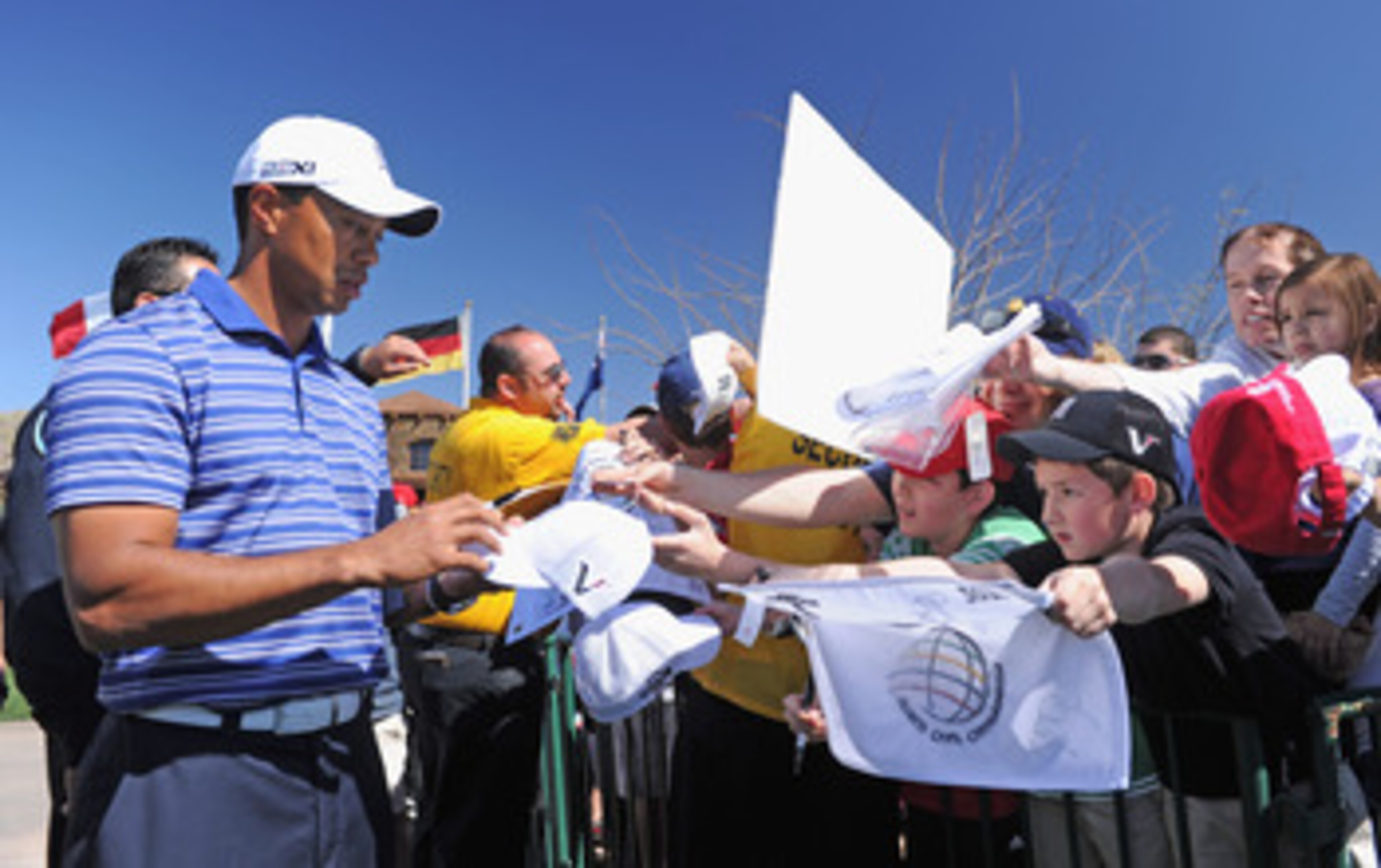 MARANA, AZ - FEBRUARY 22:  Tiger Woods signs autographs during practice prior to the start of the World Golf Championships-Accenture Match Play Championship held at The Ritz-Carlton Golf Club, Dove Mountain on February 22, 2011 in Marana, Arizona.  (Photo