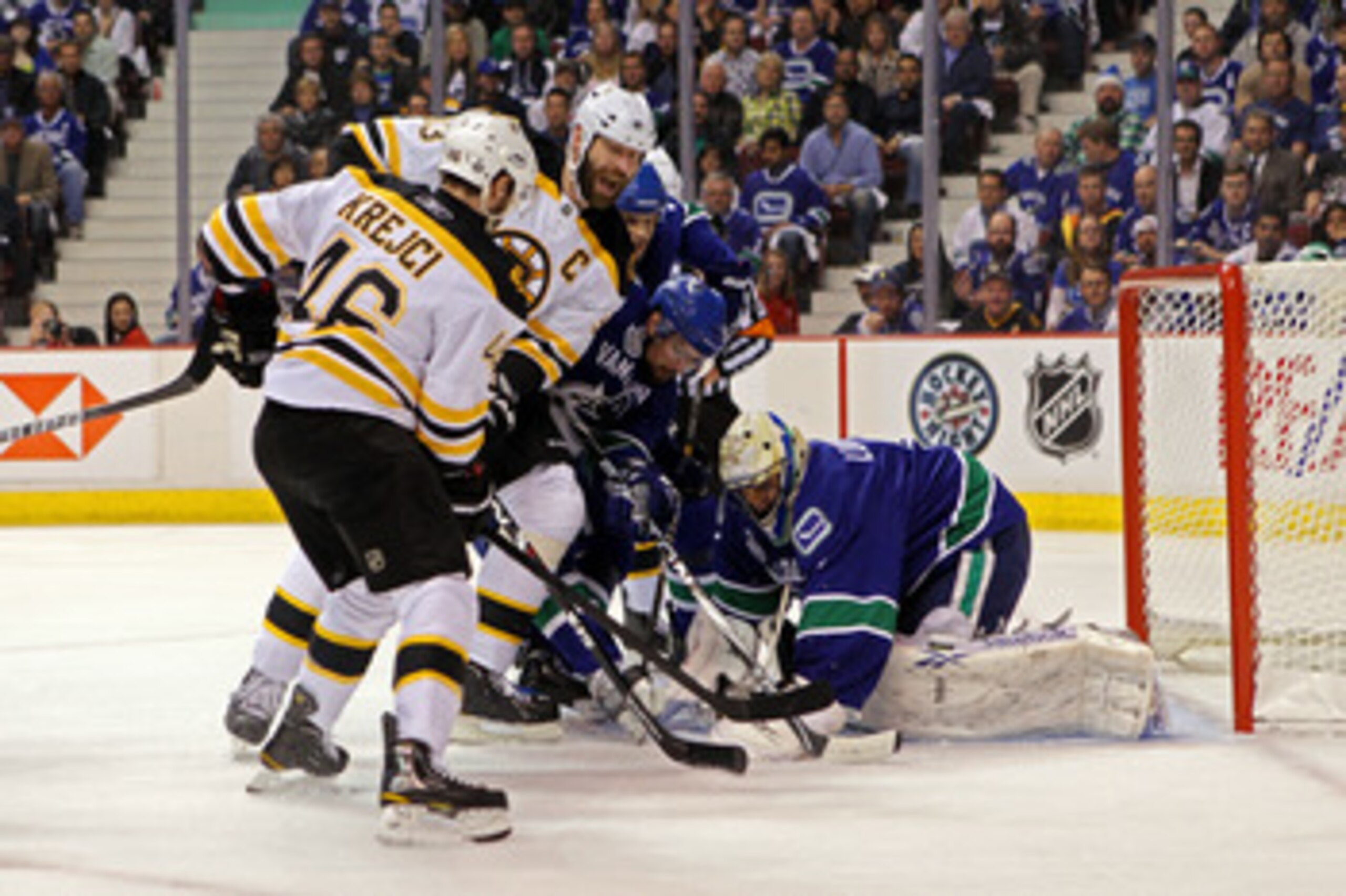 VANCOUVER, BC - JUNE 01:  Roberto Luongo #1 of the Vancouver Canucks makes save against Zdeno Chara #33 of the Boston Bruins and David Krejci #46 during game one of the 2011 NHL Stanley Cup Finals at Rogers Arena on June 1, 2011 in Vancouver, Canada.  (Ph