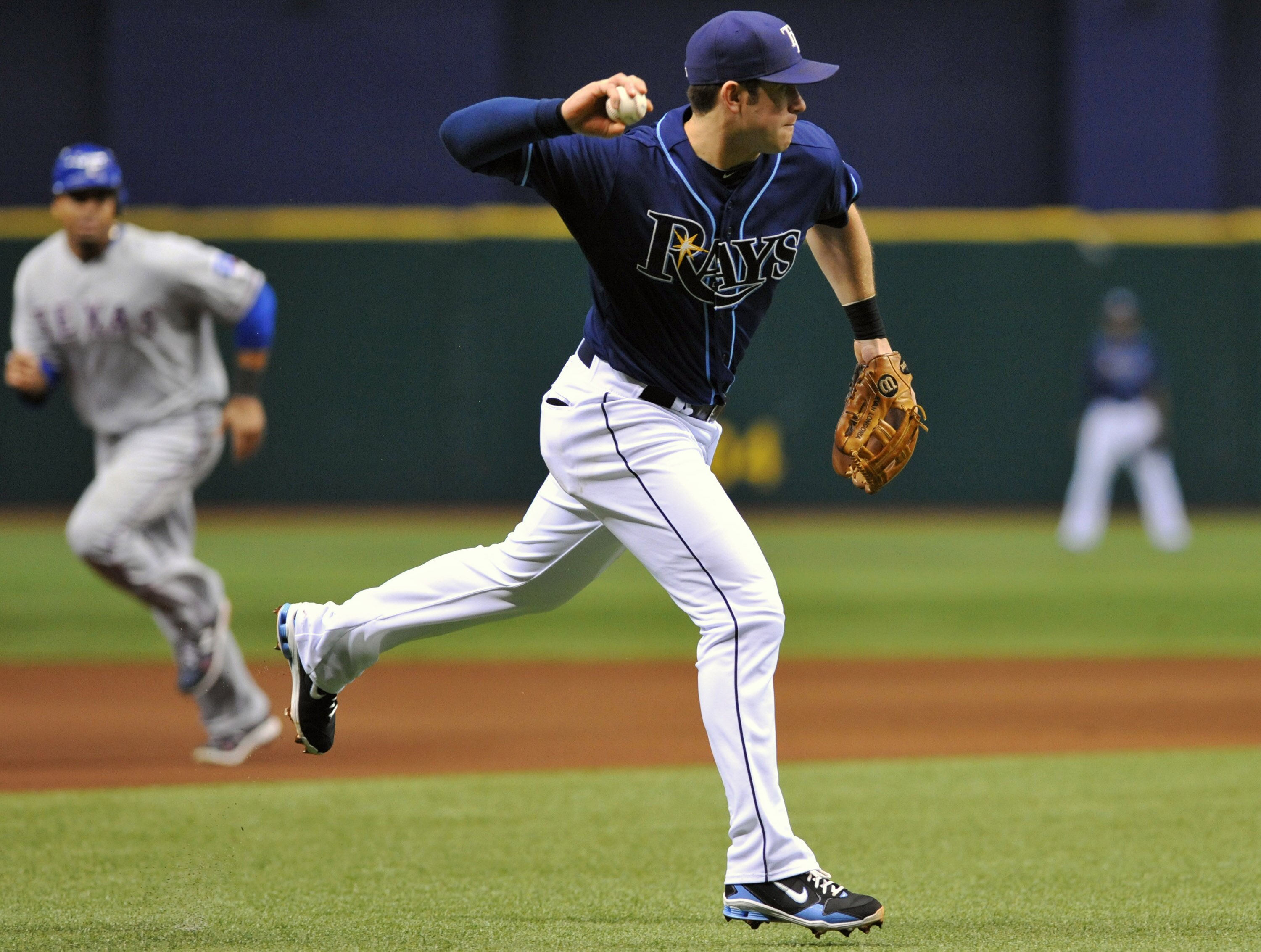 ST. PETERSBURG, FL - JUNE 1:  Third baseman Evan Longoria #3 of the Tampa Bay Rays throws to first base against the Texas Rangers June 1, 2011 at Tropicana Field in St. Petersburg, Florida.  (Photo by Al Messerschmidt/Getty Images)
