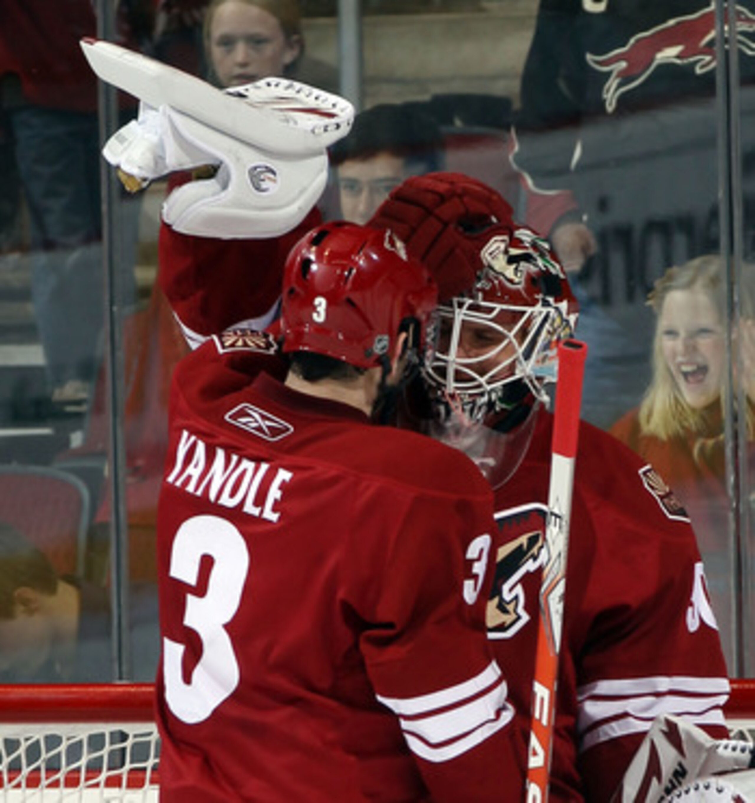 GLENDALE, AZ - FEBRUARY 07:  Ilya Bryzgalov #30  is congratulated by Keith Yandle #3 of the Phoenix Coyotes following a 3-0 shut out against the Colorado Avalanche at the Jobing.com Arena on February 7, 2011 in Glendale, Arizona. The Phoenix Coyotes defea