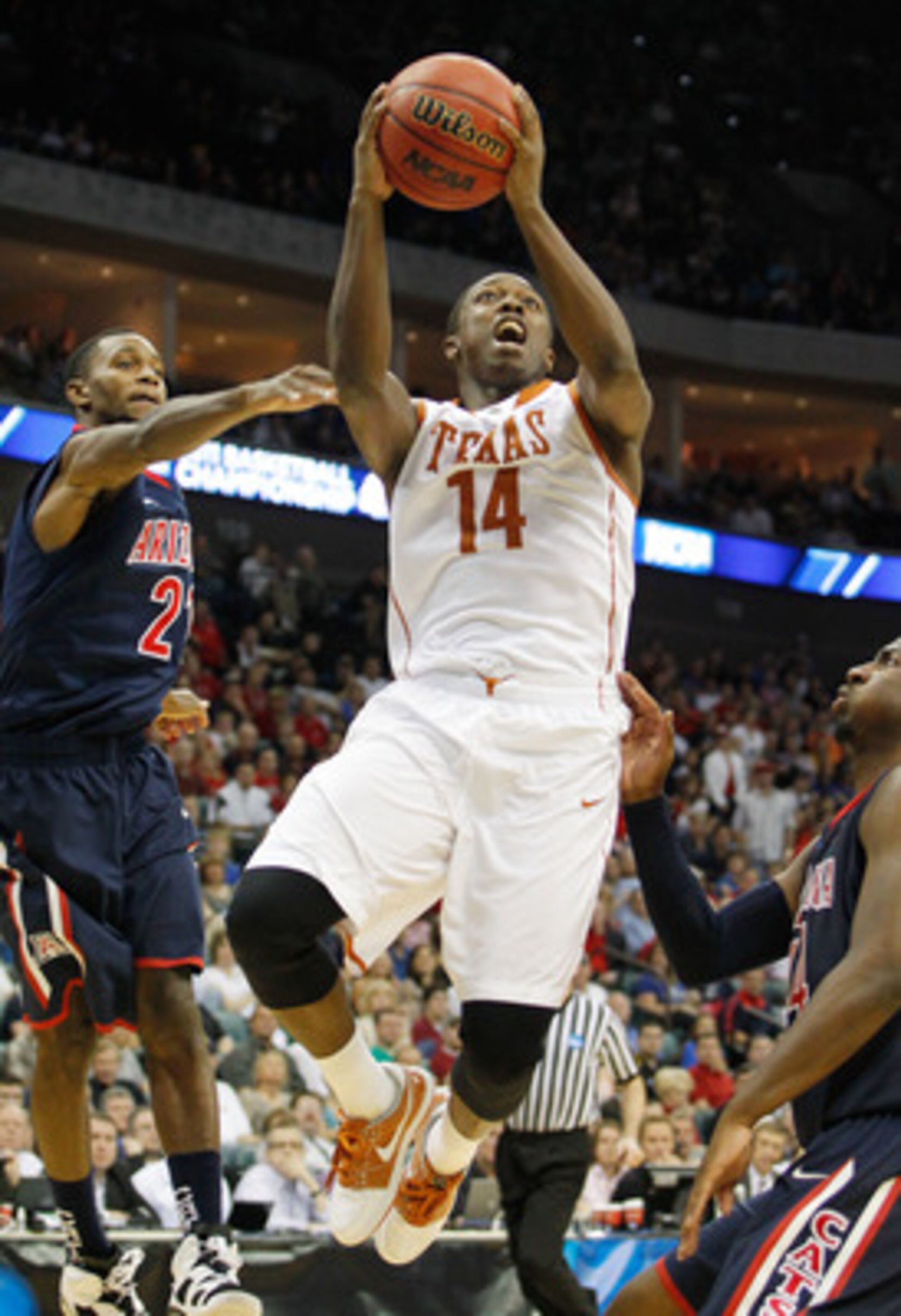 TULSA, OK - MARCH 20:  J'Covan Brown #14 of the Texas Longhorns goes up for a shot against the Arizona Wildcats during the third round of the 2011 NCAA men's basketball tournament at BOK Center on March 20, 2011 in Tulsa, Oklahoma.  (Photo by Tom Penningt