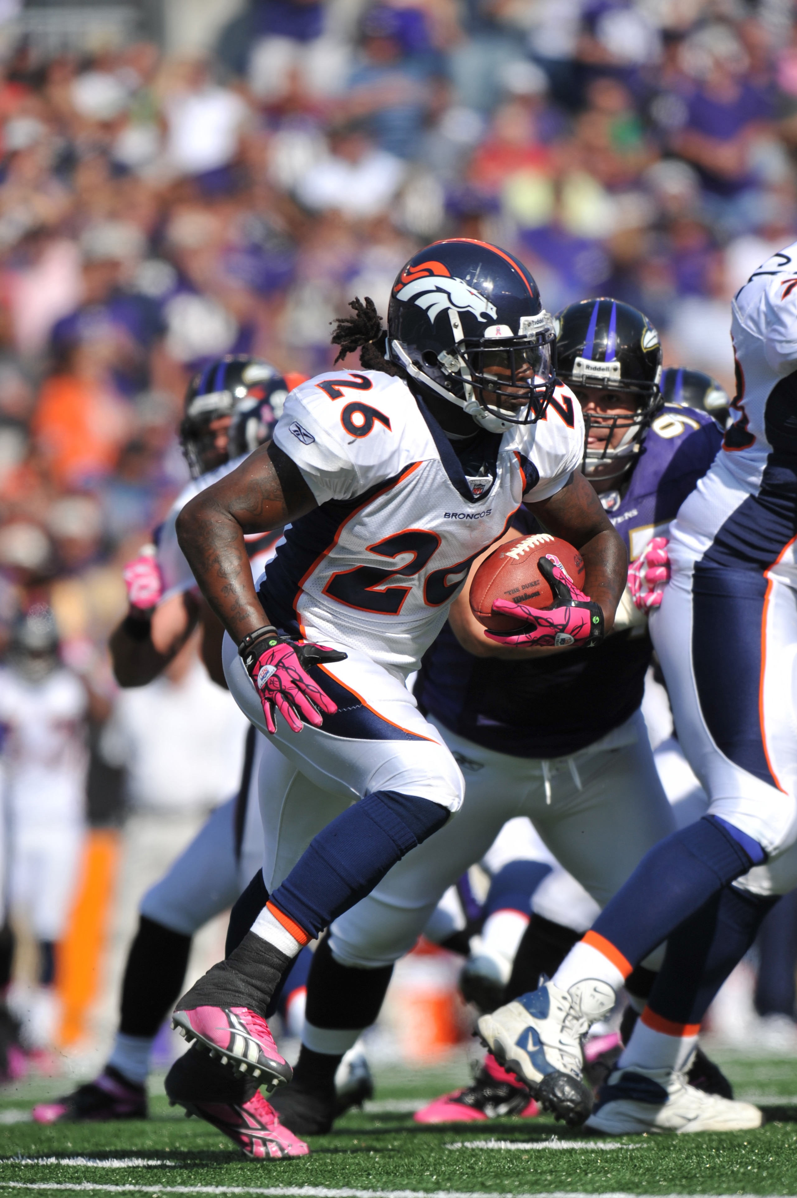 BALTIMORE, MD - OCTOBER 10: Laurence Maroney #26 of the Denver Broncos runs the ball against the Baltimore Ravens at M&T Bank Stadium on October 10, 2010 in Baltimore, Maryland. Players wore pink in recognition of Breast Cancer Awareness Month. The Ravens BALTIMORE, MD - OCTOBER 10: Laurence Maroney #26 of the Denver Broncos runs the ball against the Baltimore Ravens at M&T Bank Stadium on October 10, 2010 in Baltimore, Maryland. Players wore pink in recognition of Breast Cancer Awareness Month. The Ravens