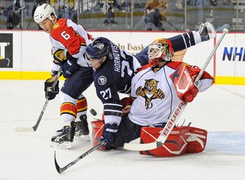 NASHVILLE, TN - DECEMBER 11:  Patric Hornqvist #27 of the Nashville Predators moves behind Dennis Wideman #6 of the Florida Panthers and interferes with Panthers goalie Tomas Vokoun #29 on December 11, 2010 at the Bridgestone Arena in Nashville, Tennessee