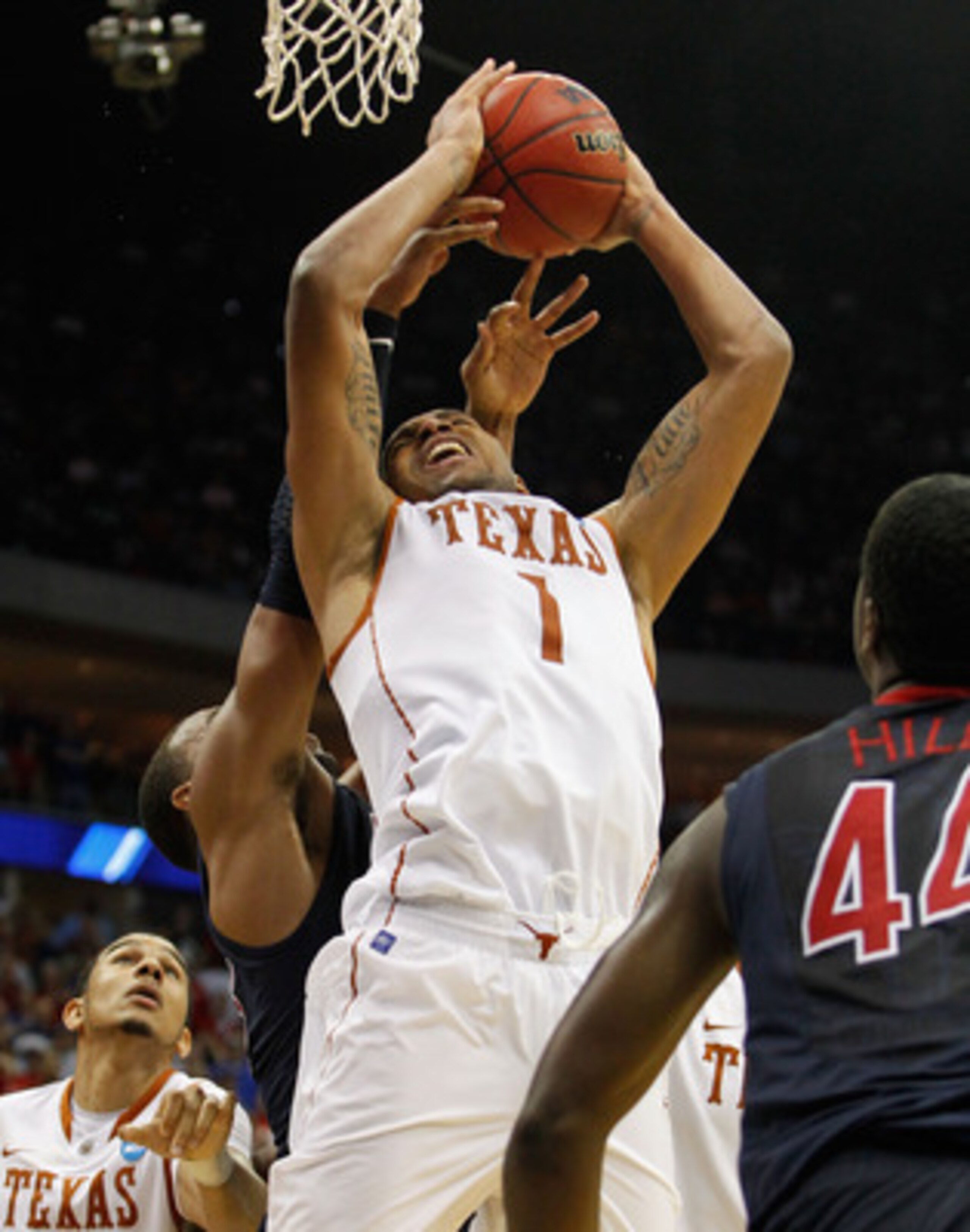 TULSA, OK - MARCH 20:  Gary Johnson #1 of the Texas Longhorns grabs a rebound in the final moments of their 70-69 loss to the Arizona Wildcats during the third round of the 2011 NCAA men's basketball tournament at BOK Center on March 20, 2011 in Tulsa, Ok