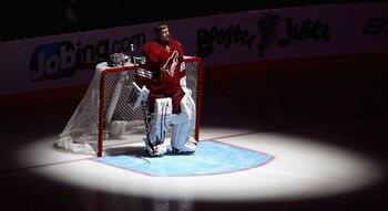 GLENDALE, AZ - APRIL 20:  Goaltender Ilya Bryzgalov #30 of the Phoenix Coyotes stands attended for the National Anthem before Game Four of the Western Conference Quarterfinals against the Detroit Red Wings during the 2011 NHL Stanley Cup Playoffs at Jobin