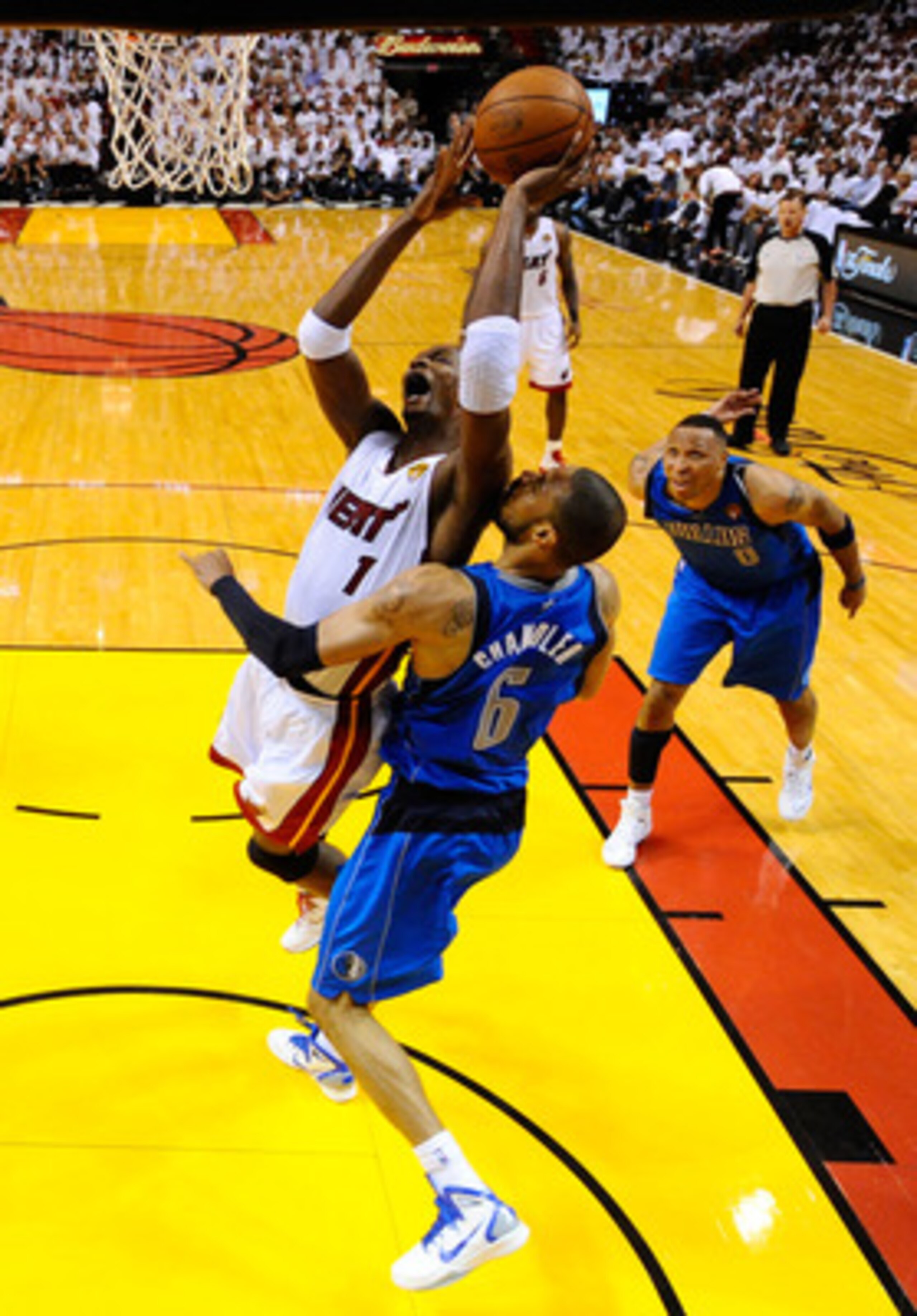MIAMI, FL - MAY 31:  Chris Bosh #1 of the Miami Heat drives for a shot attempt against Tyson Chandler #6 of the Dallas Mavericks in Game One of the 2011 NBA Finals at American Airlines Arena on May 31, 2011 in Miami, Florida. NOTE TO USER: User expressly 