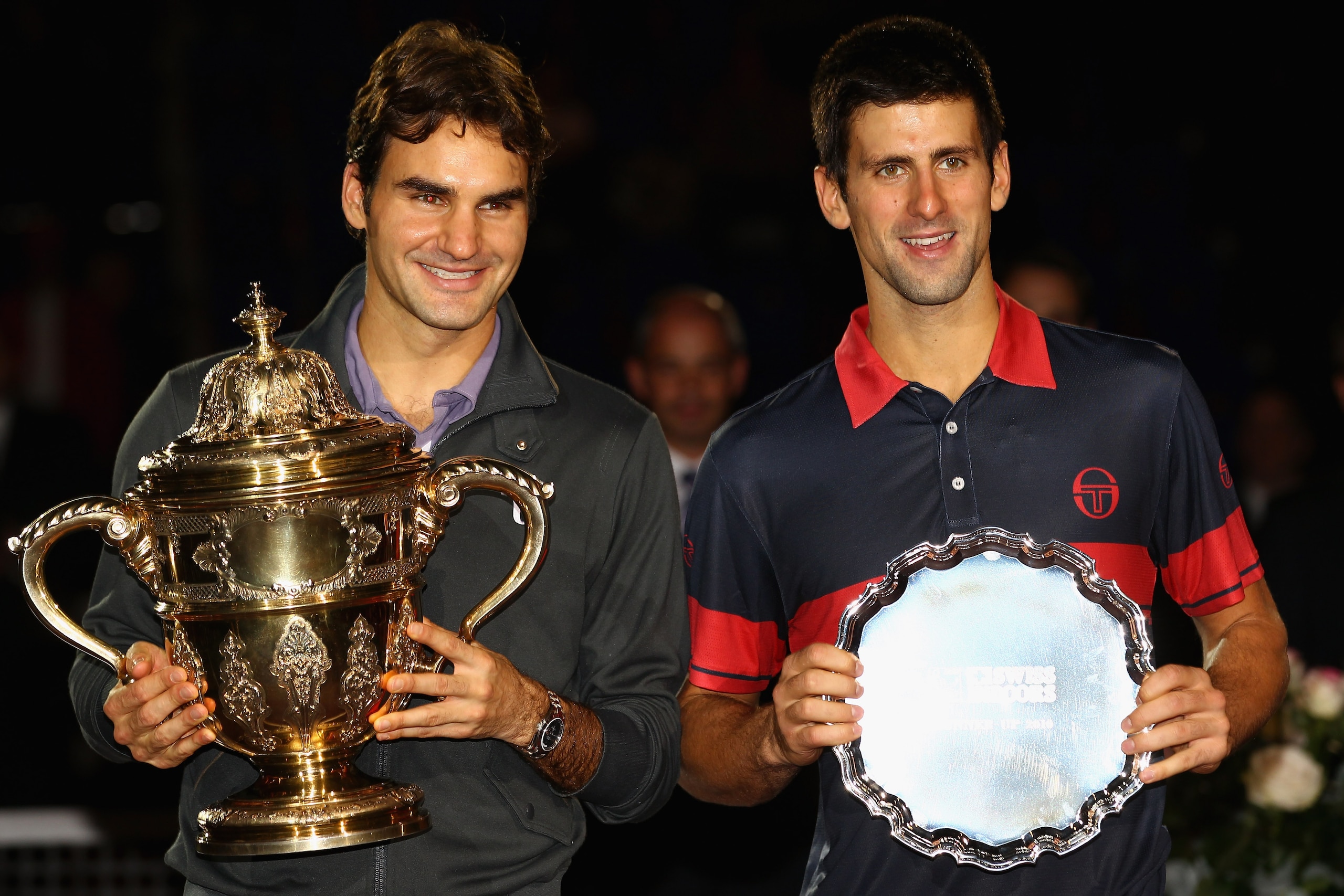 BASEL, SWITZERLAND - NOVEMBER 07:  Roger Federer of Switzerland with the winners trophy next to runner up, Novak Djokovic of Serbia after the final during Day Seven of the Davidoff Swiss Indoors Tennis at St Jakobshalle on November 7, 2010 in Basel, Switz