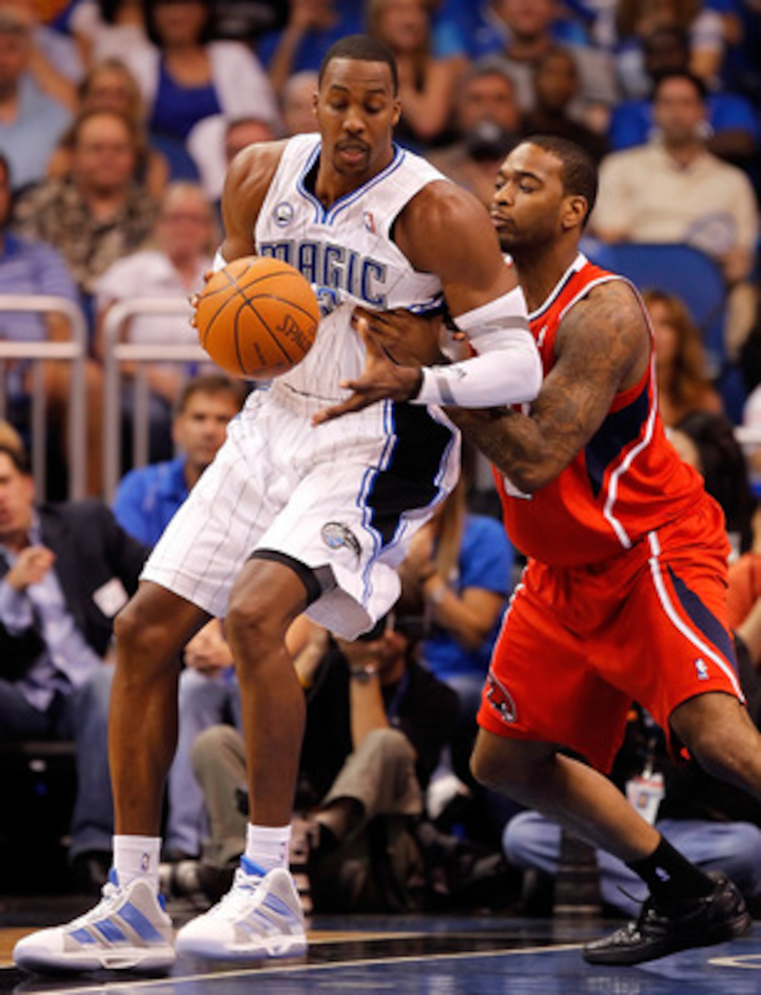 ORLANDO, FL - APRIL 16:  Dwight Howard #12 of the Orlando Magic drives on Jason Collins #34 of the Atlanta Hawks during Game One of the Eastern Conference Quarterfinals of the 2011 NBA Playoffs on April 16, 2011 at the Amway Arena in Orlando, Florida.  NO