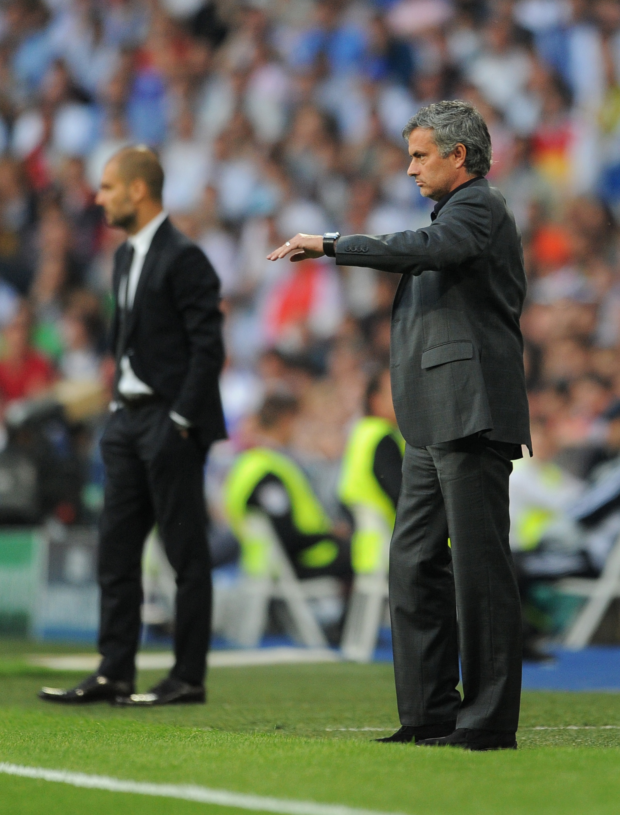 MADRID, SPAIN - APRIL 27:  Head coach Jose Mourinho (R) of Real Madrid stands backdropped by head coach Josep Guardiola of Barcelona during the UEFA Champions League Semi Final first leg match between Real Madrid and Barcelona at the Estadio Santiago Bern