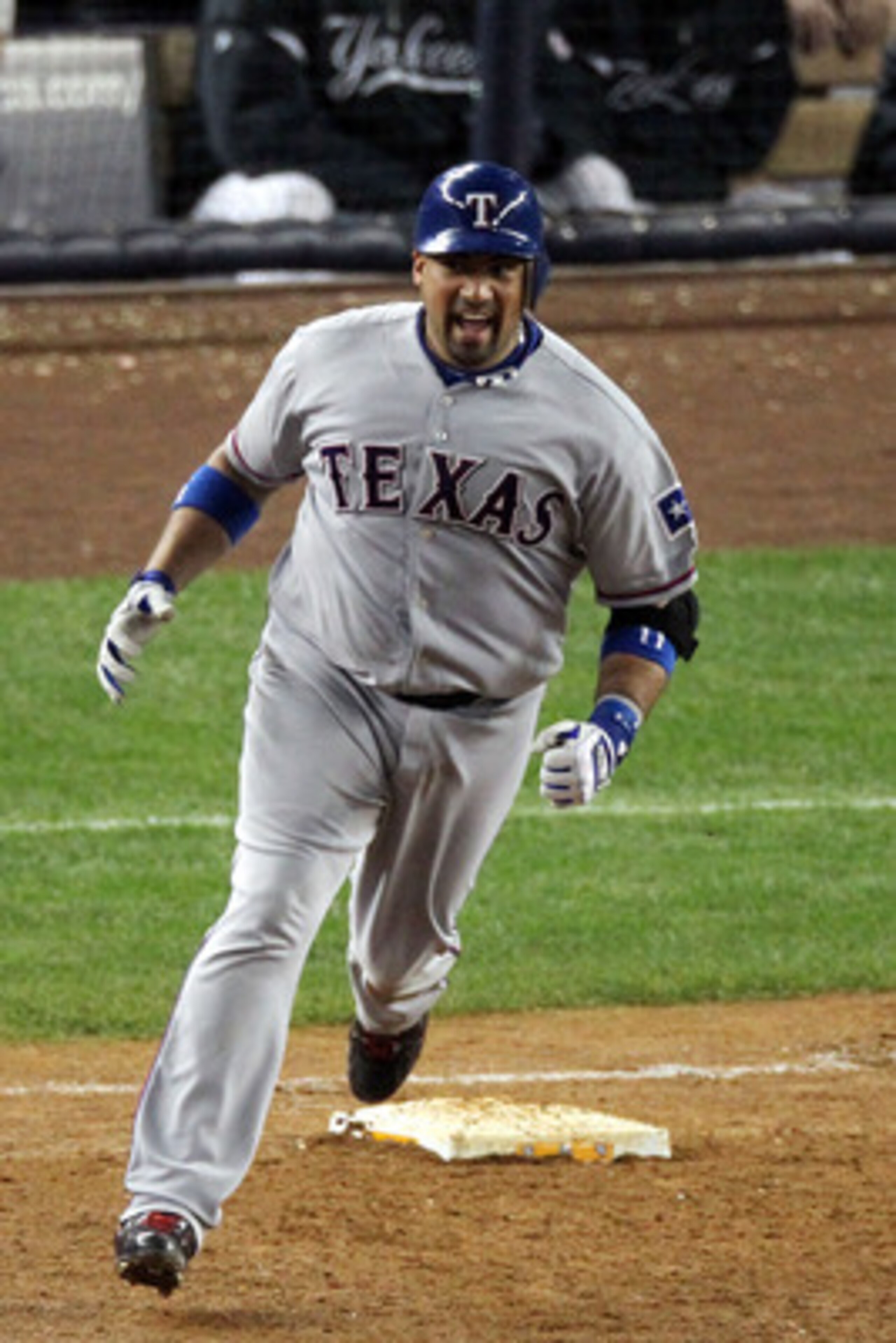 NEW YORK - OCTOBER 19:  Bengie Molina #11 of the Texas Rangers celebrates after hitting a three-run home run in the top of the sixth inning against A.J. Burnett #34 of the New York Yankees  in Game Four of the ALCS during the 2010 MLB Playoffs at Yankee S